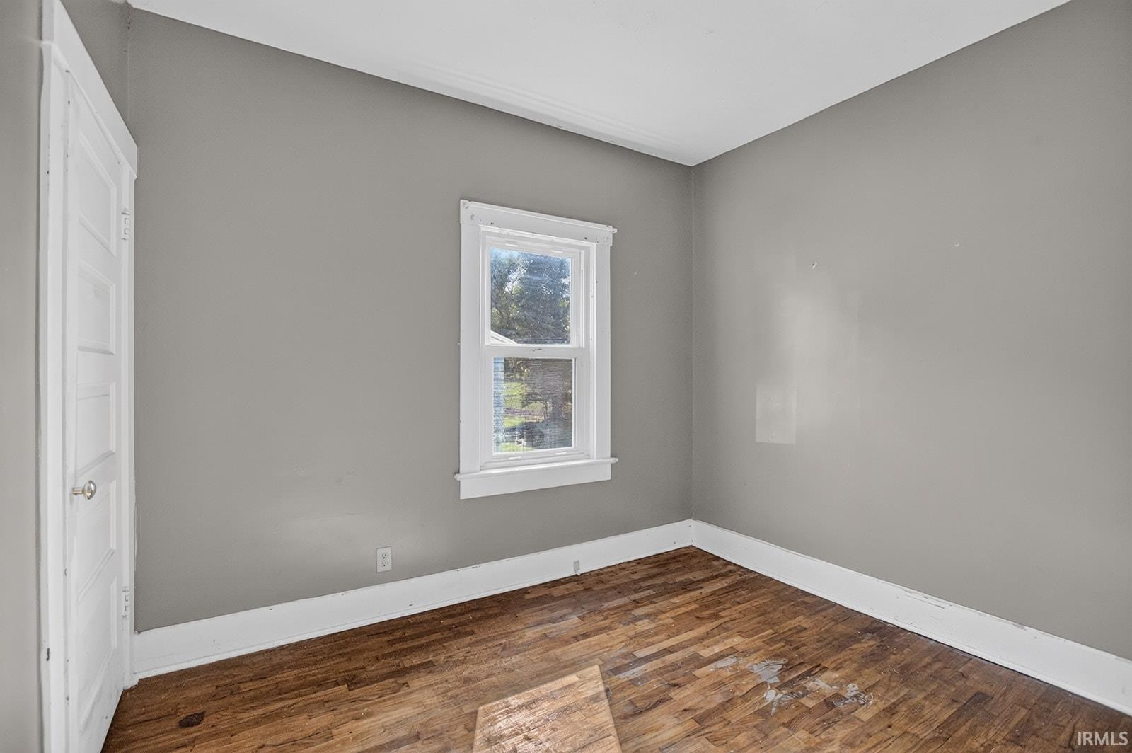 Hardwood floor, window, closet and door to attic stairway