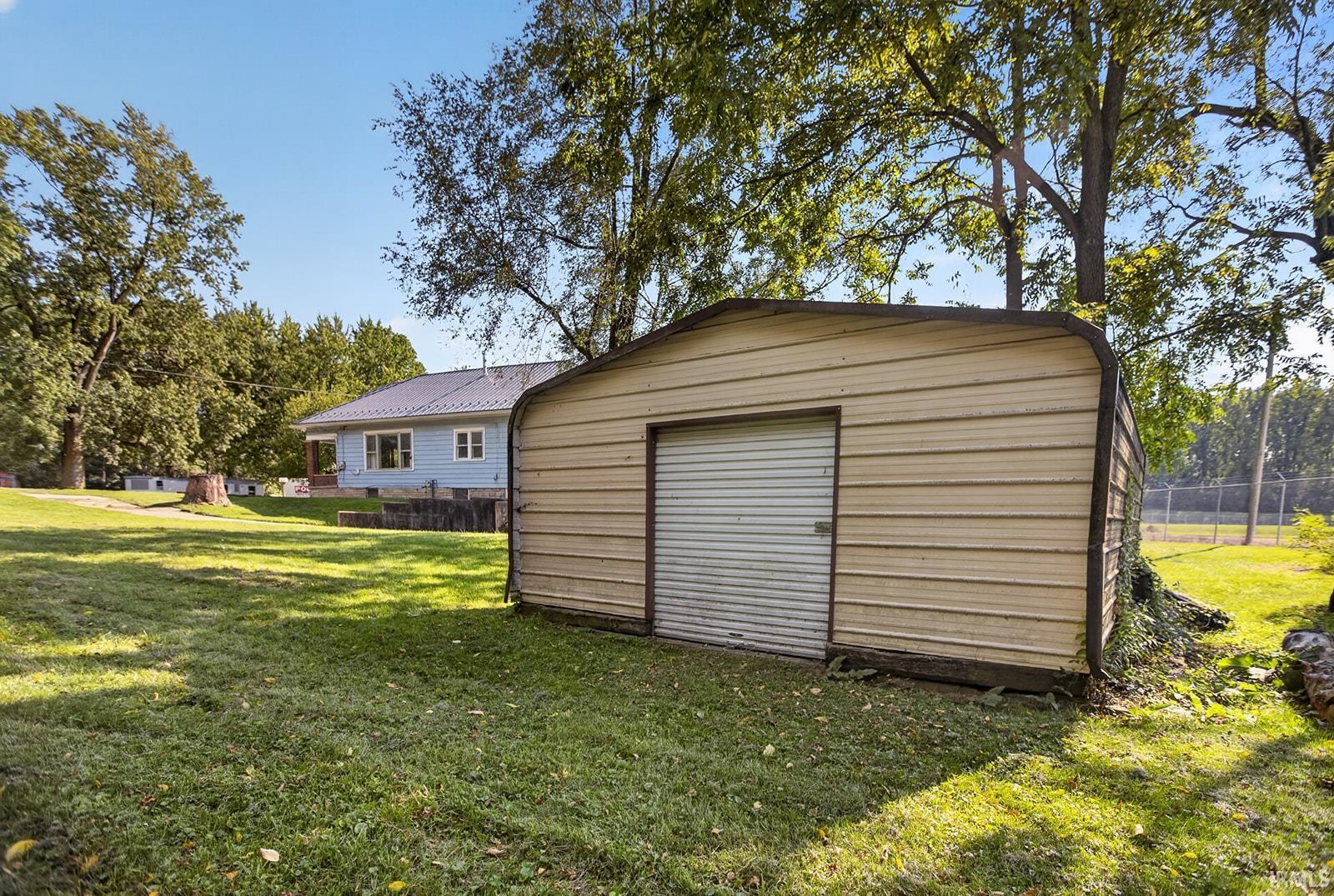 Detached storage shed with roll-up door