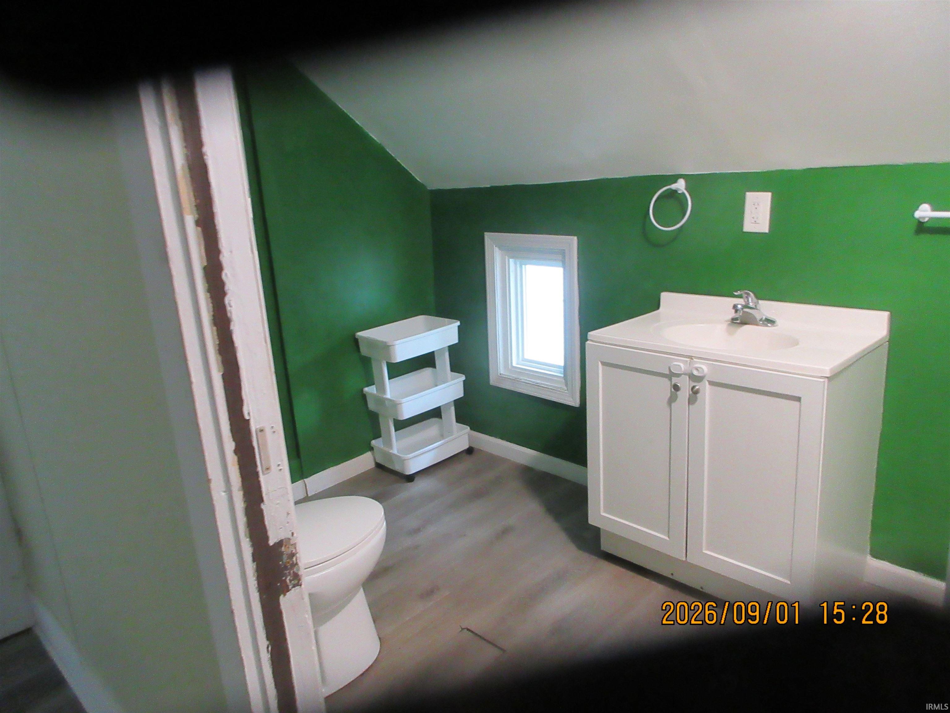 White vanity with integrated sink, chrome faucet, and white cabinetry