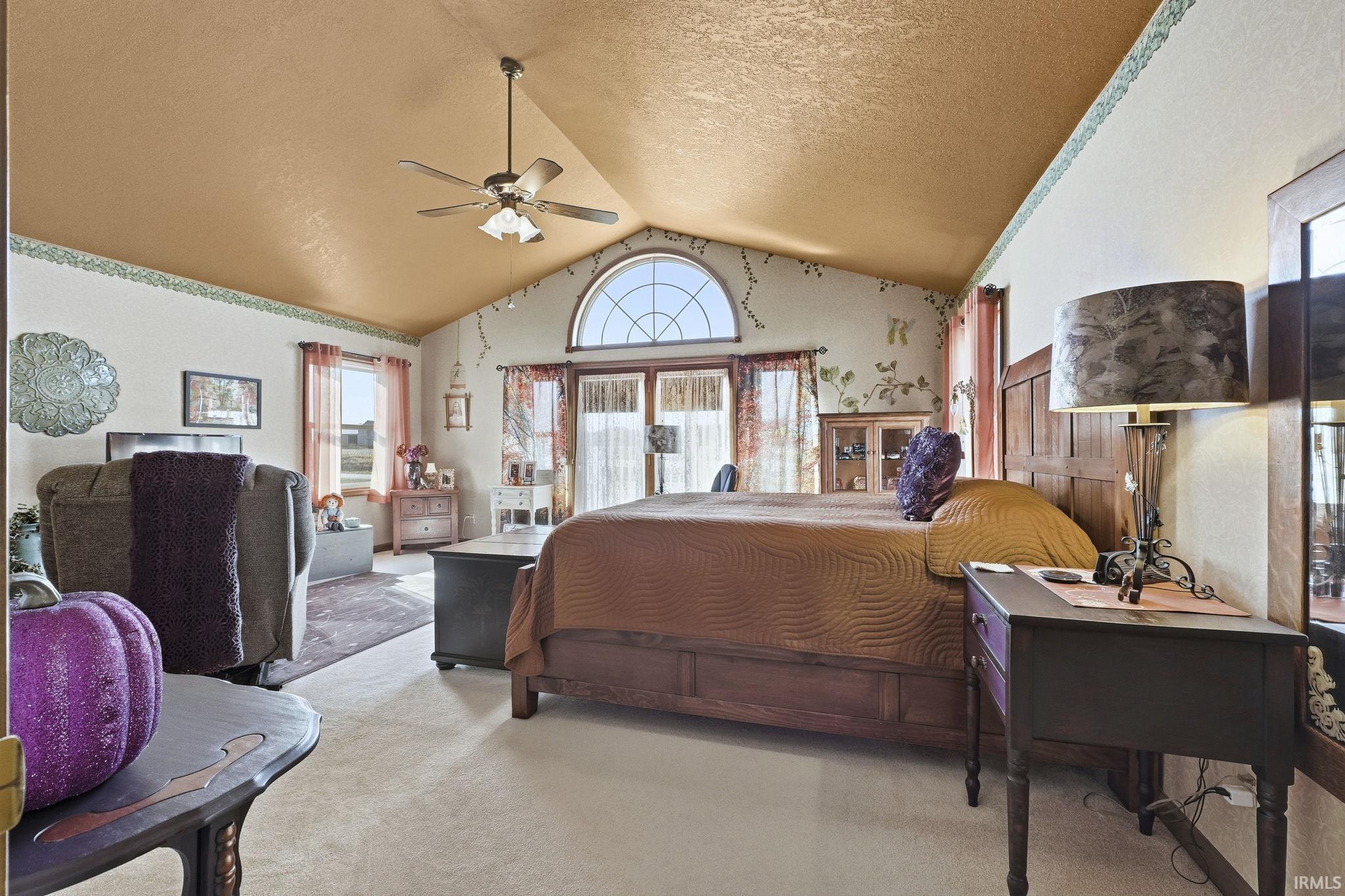 Vaulted ceiling, arched window, and central ceiling fan