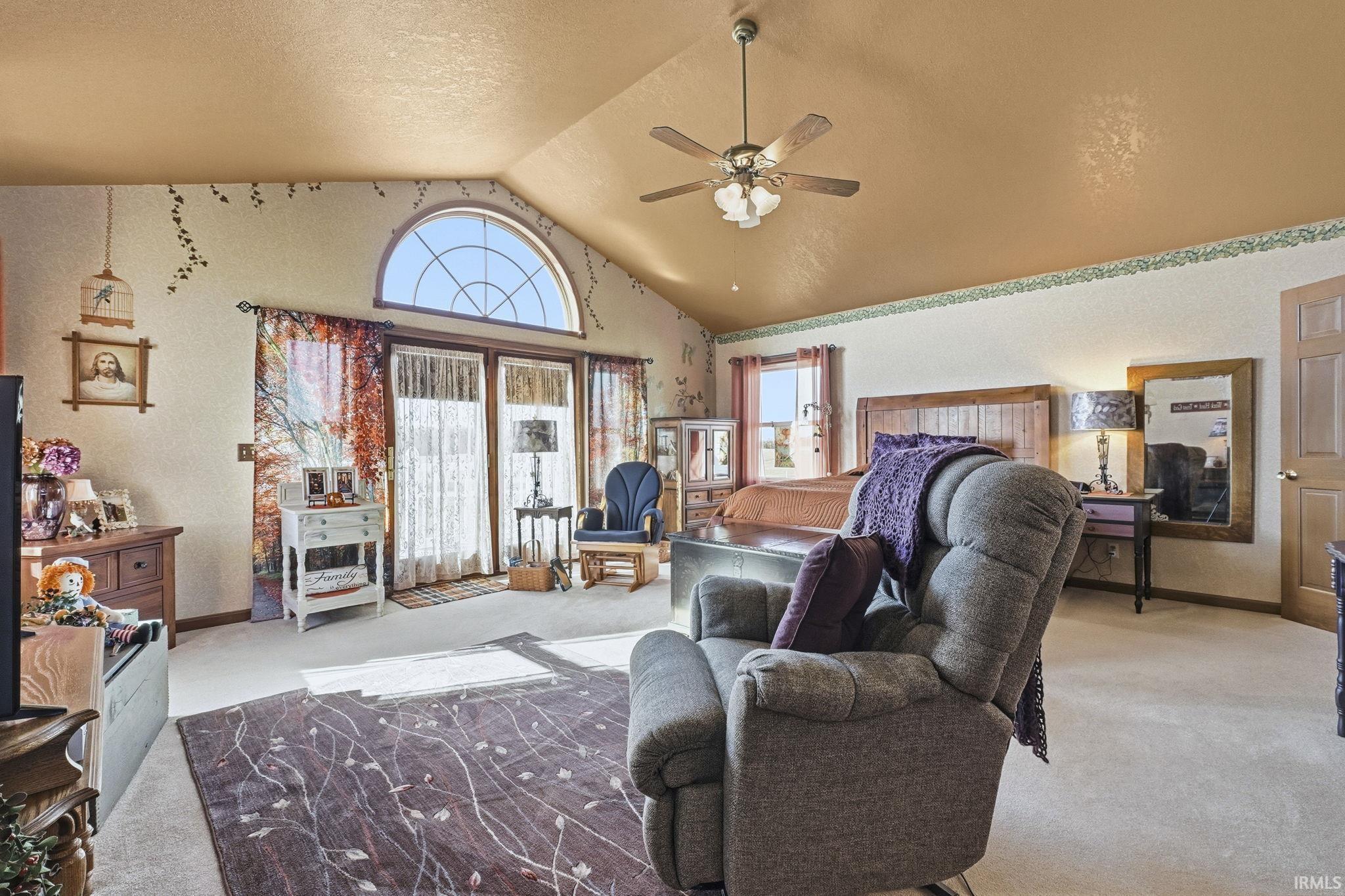 Vaulted ceilings, arched transom window, integrated ceiling fan, and solid-core interior doors