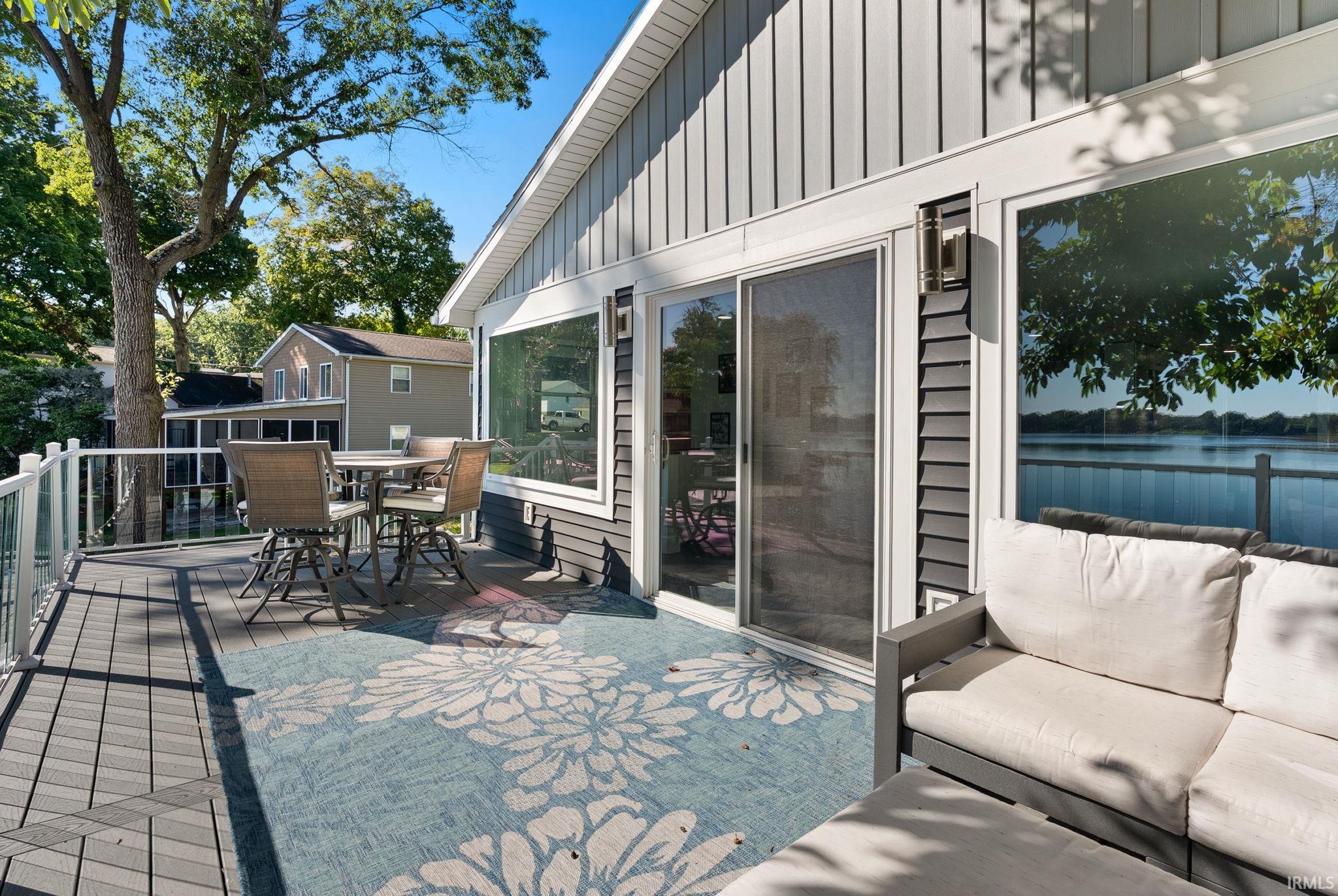 Expansive deck with composite decking, glass panel railing, and water views