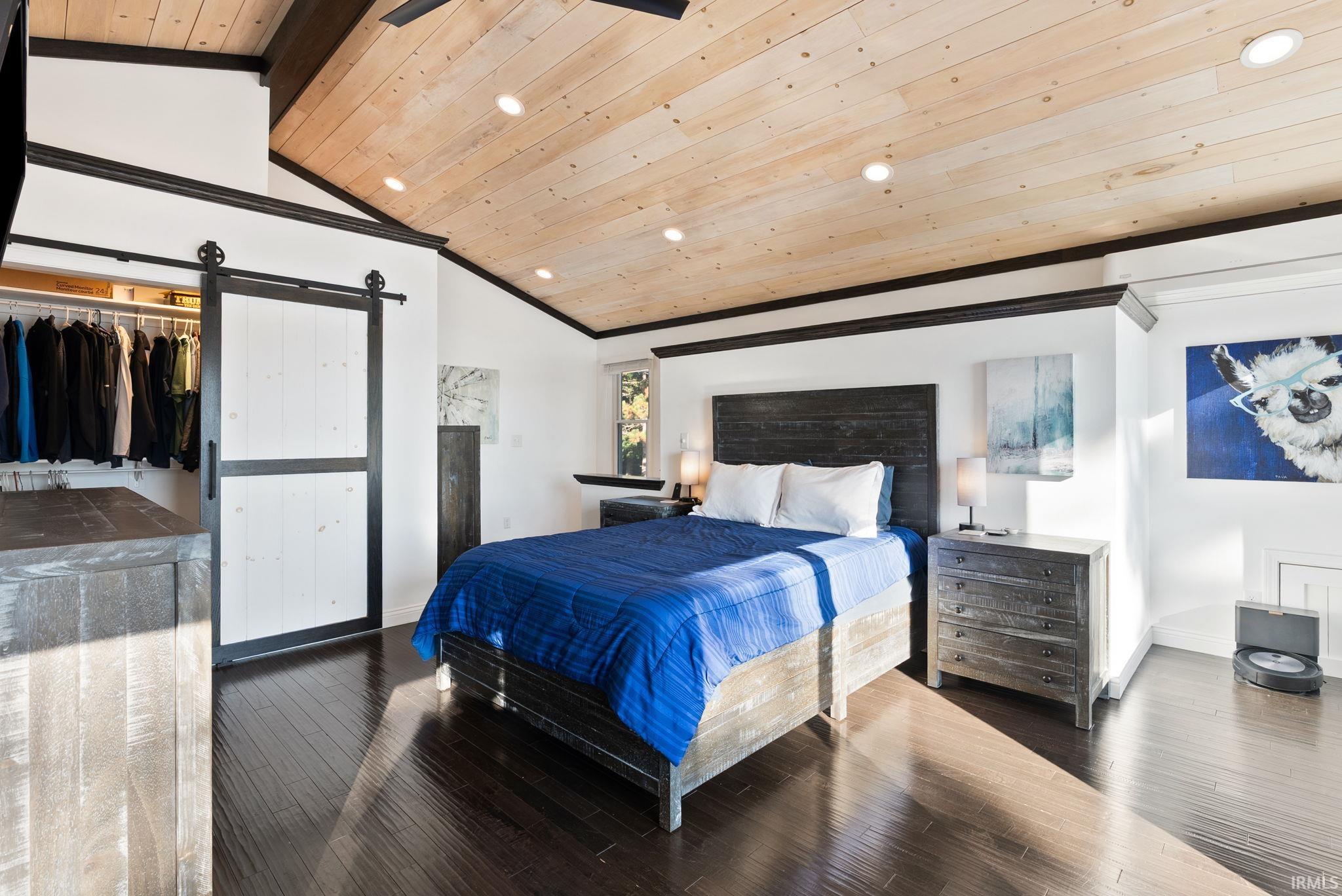 Vaulted wood-paneled ceiling with recessed lighting