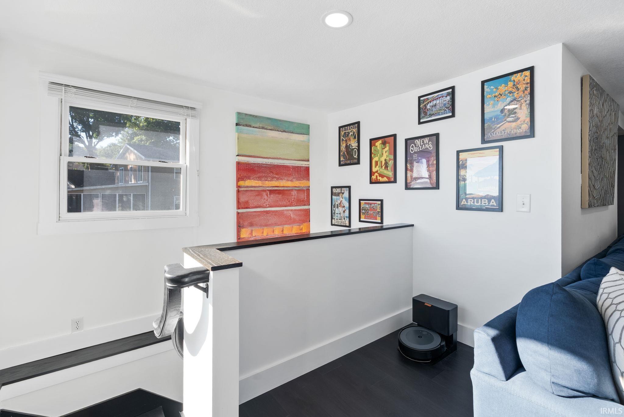 Recessed lighting illuminates wood-finish flooring