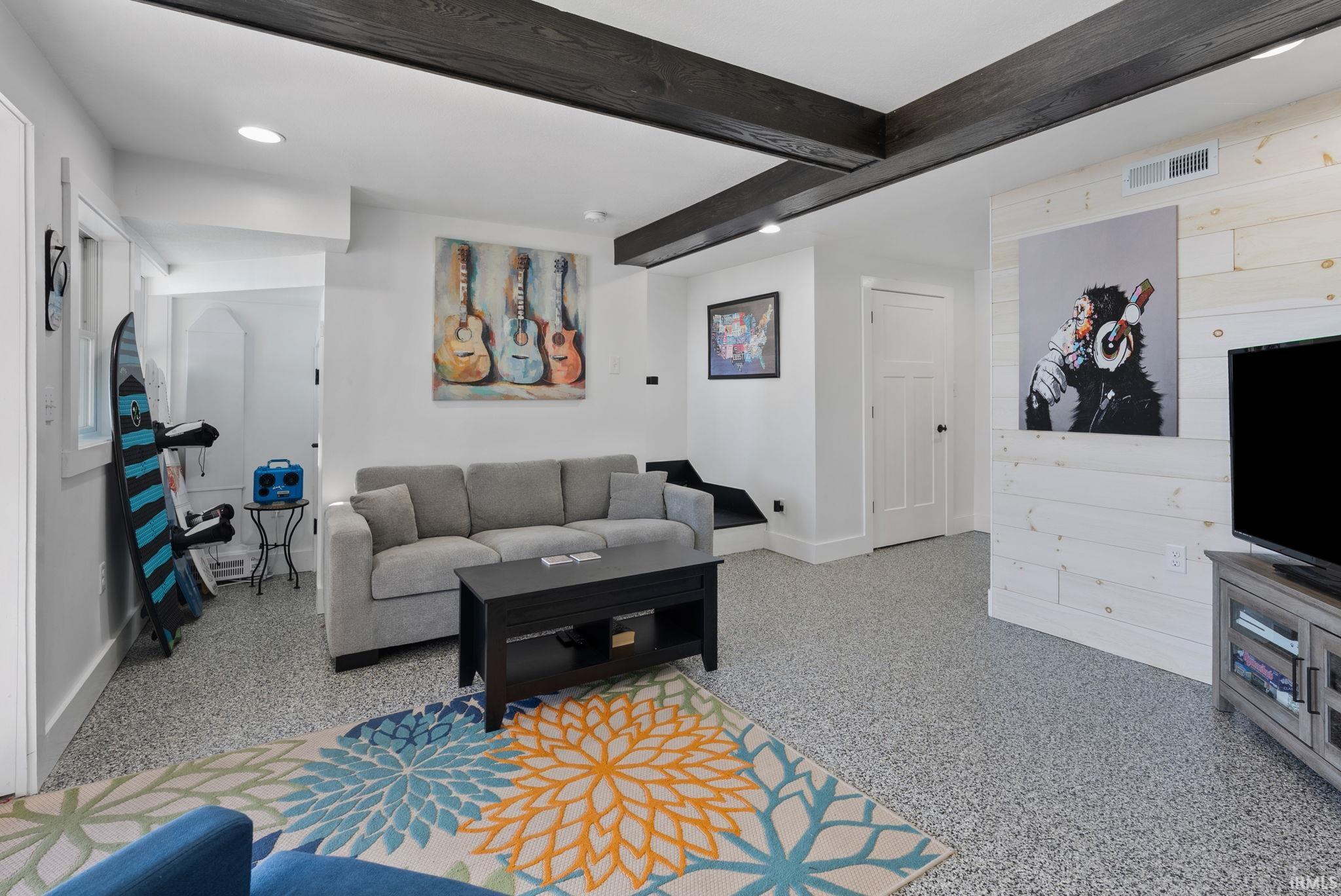 Exposed wood beams, recessed lighting, and durable speckled flooring