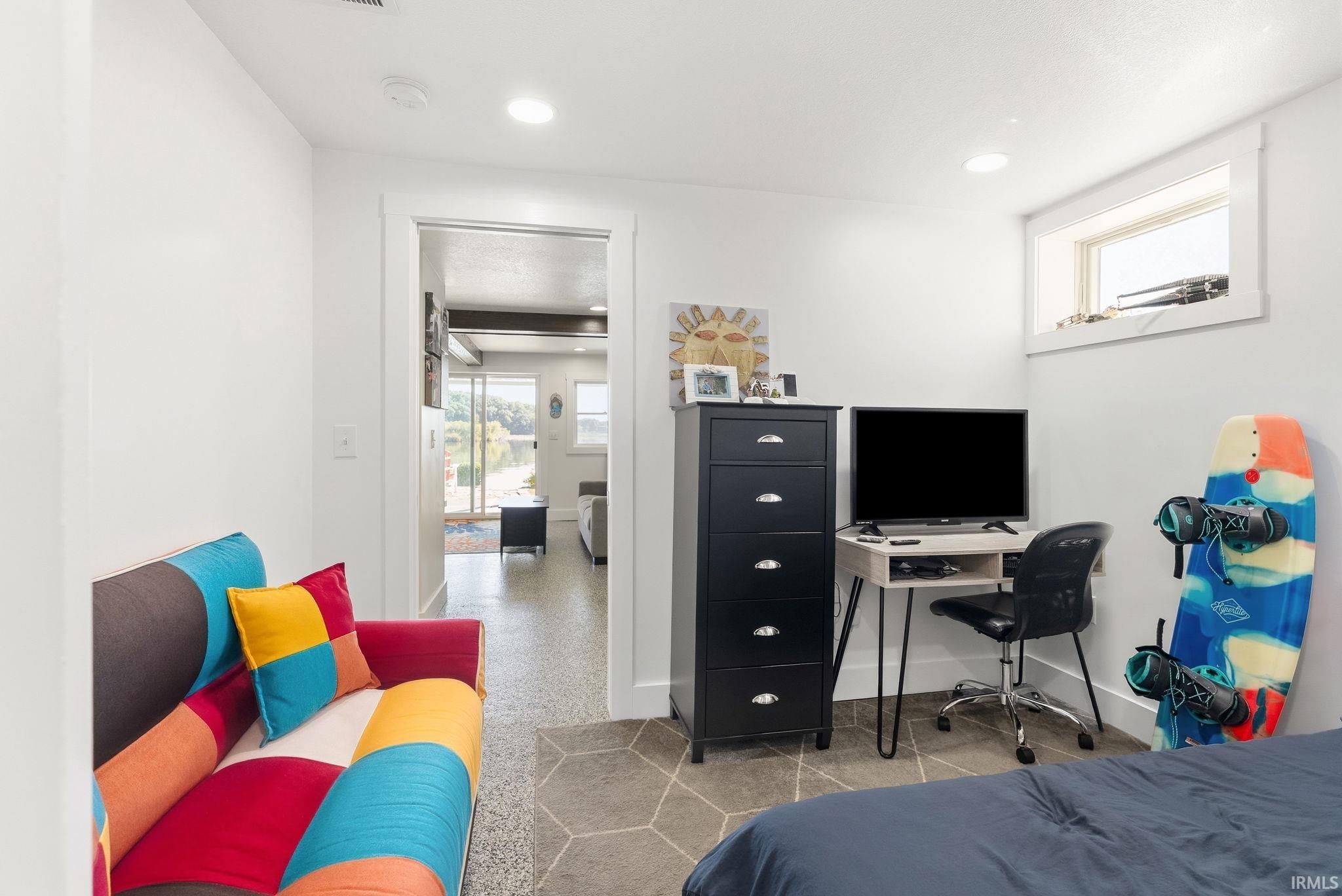 Recessed lighting, polygonal floor tiles, white trim, and a high window