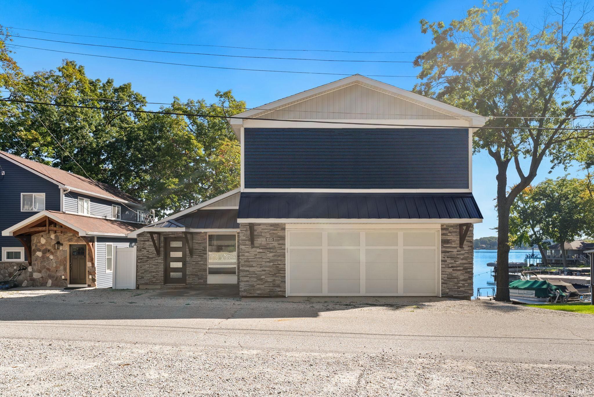 Contemporary exterior with dark blue siding and stone veneer accents