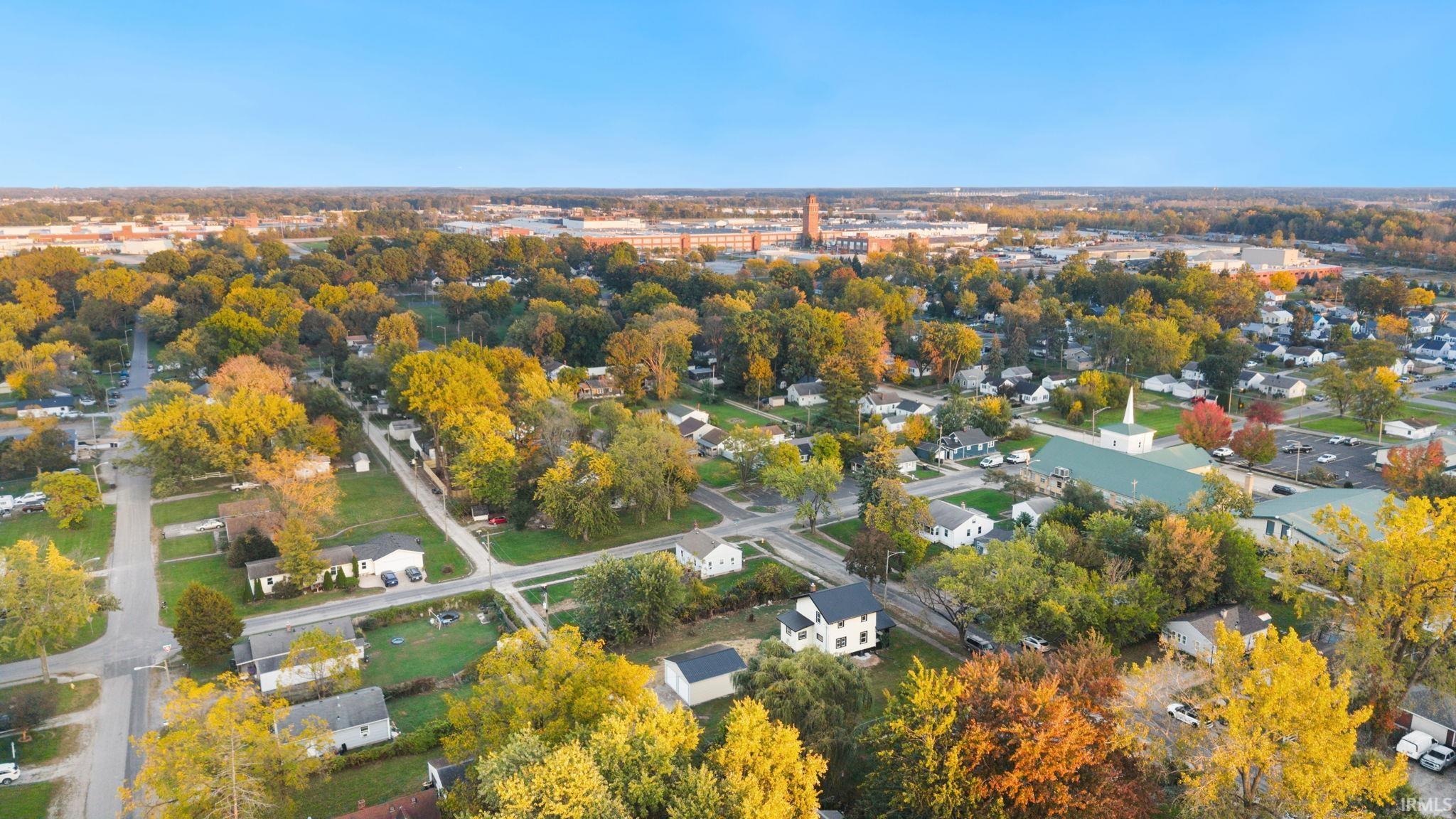 Aerial perspective featuring a mature residential landscape, established canopy trees, and local street infrastructure