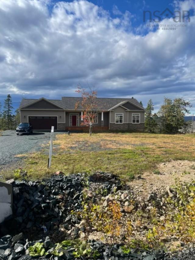 1097 Fleetwood Drive, Fall River, NS (MLS® 202615334) — Single-story residence featuring horizontal siding, stone veneer accents, a covered front porch with columns, and an attached two-car garage
