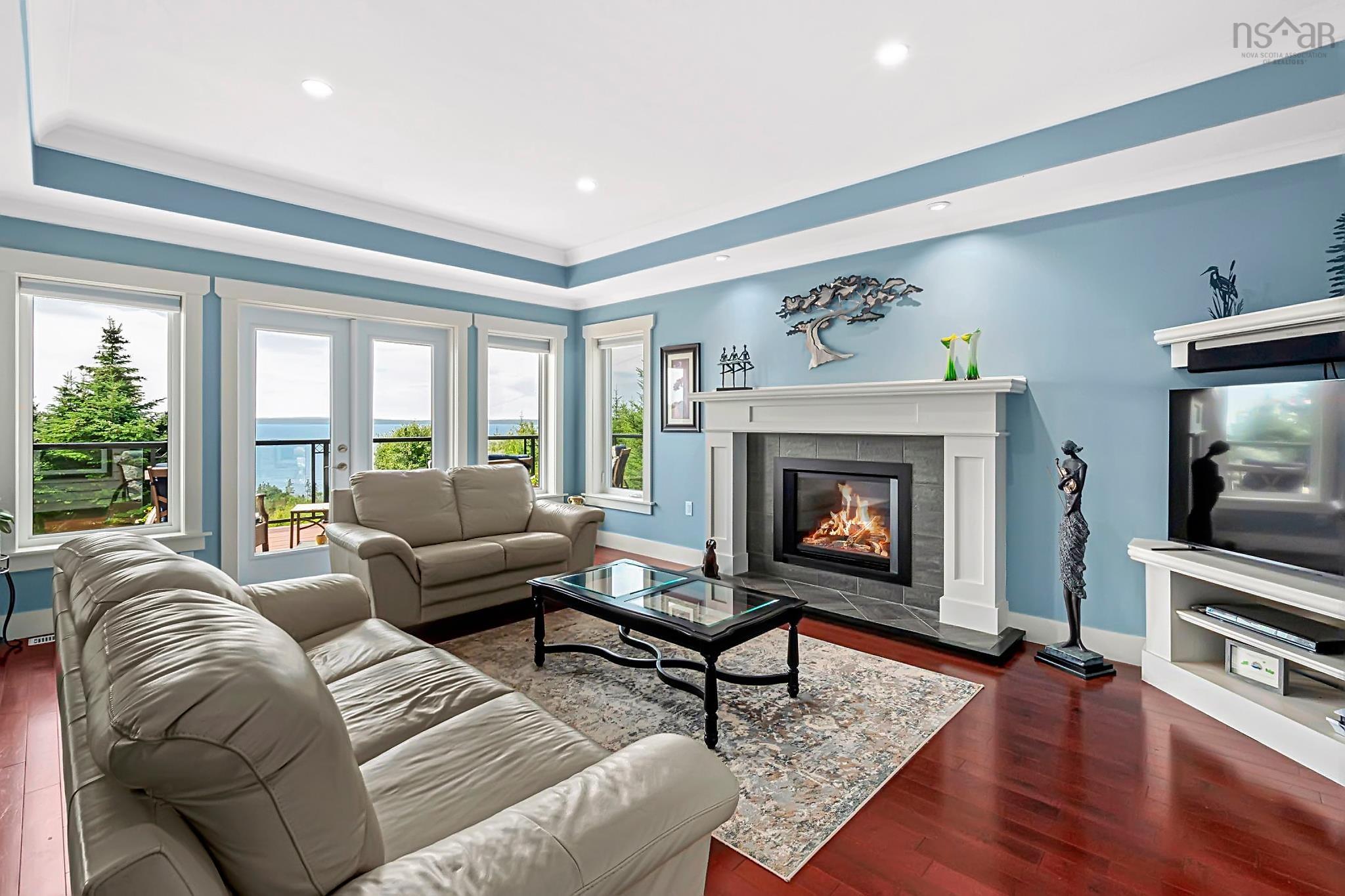 116 Whitecap Ridge, Black Point, NS (MLS® 202618413) — Living area featuring wood-finish flooring and a tray ceiling with recessed lighting
