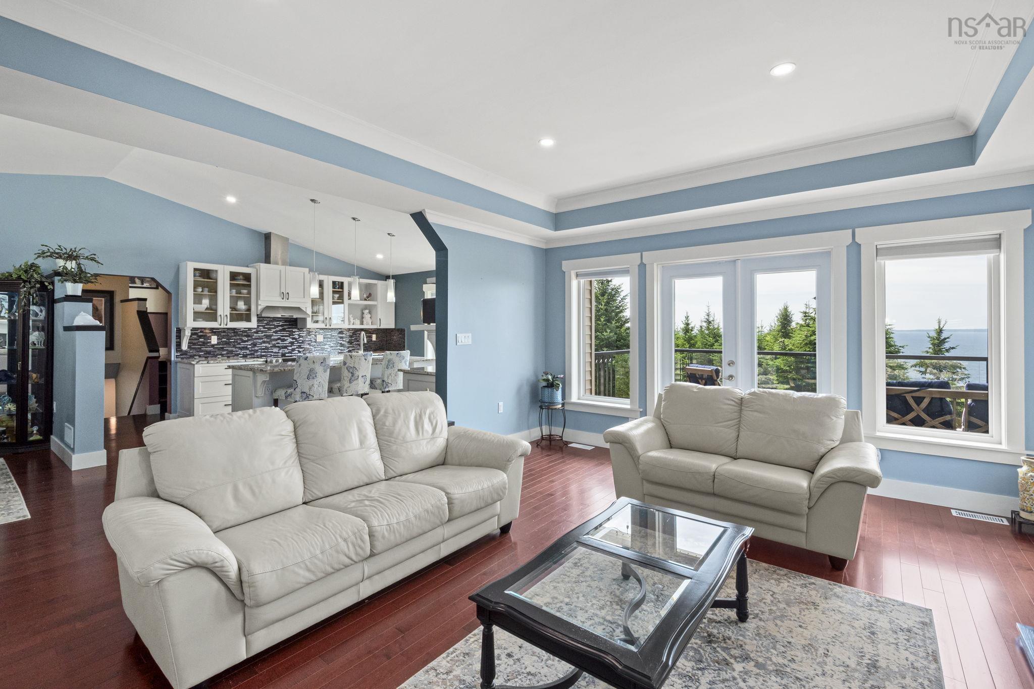 116 Whitecap Ridge, Black Point, NS (MLS® 202618413) — Living area featuring hardwood-finish flooring, recessed lighting, and a tray ceiling