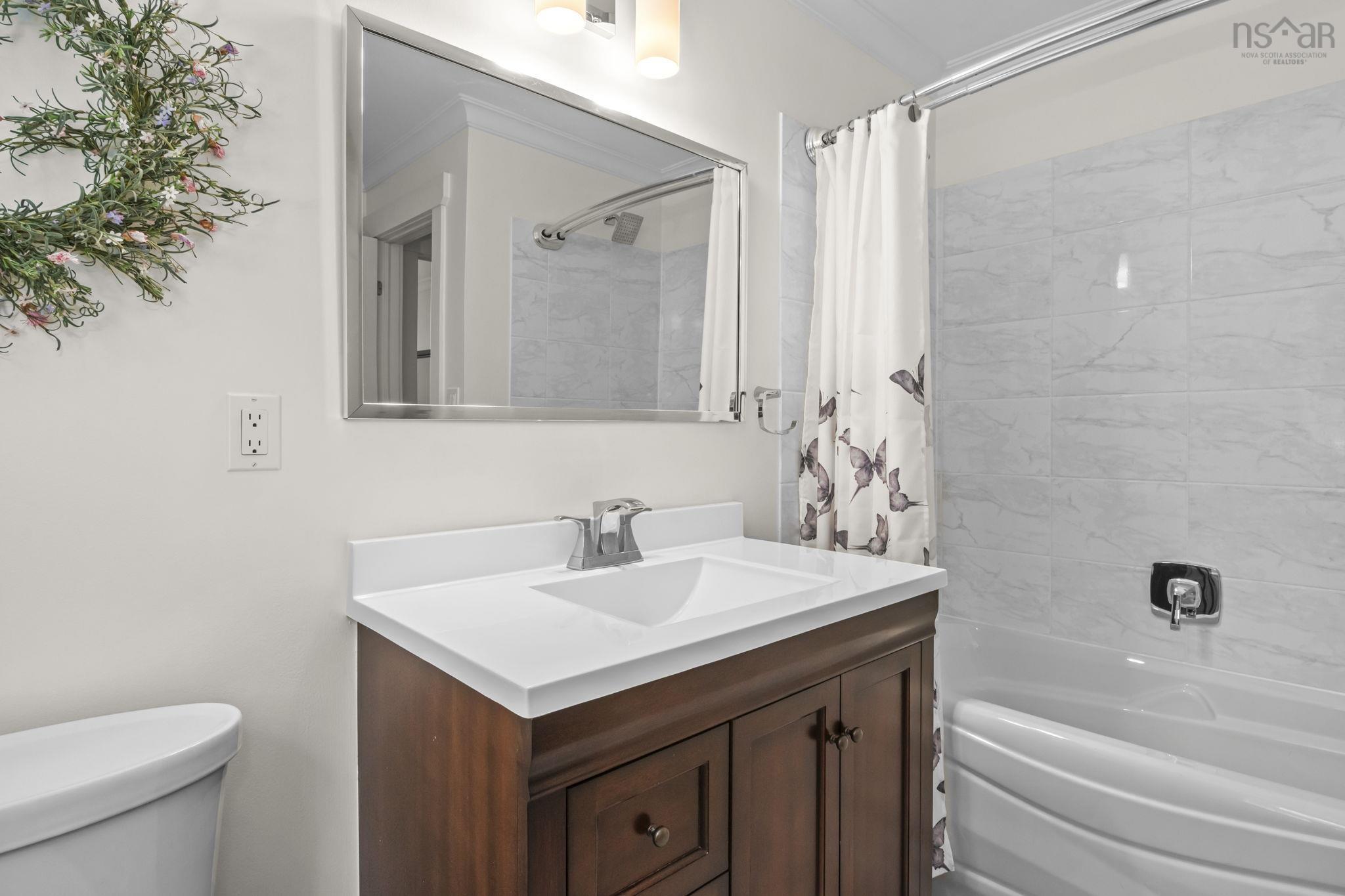 116 Whitecap Ridge, Black Point, NS (MLS® 202618413) — Bathroom featuring a dark wood-finish vanity with a white countertop and integrated sink