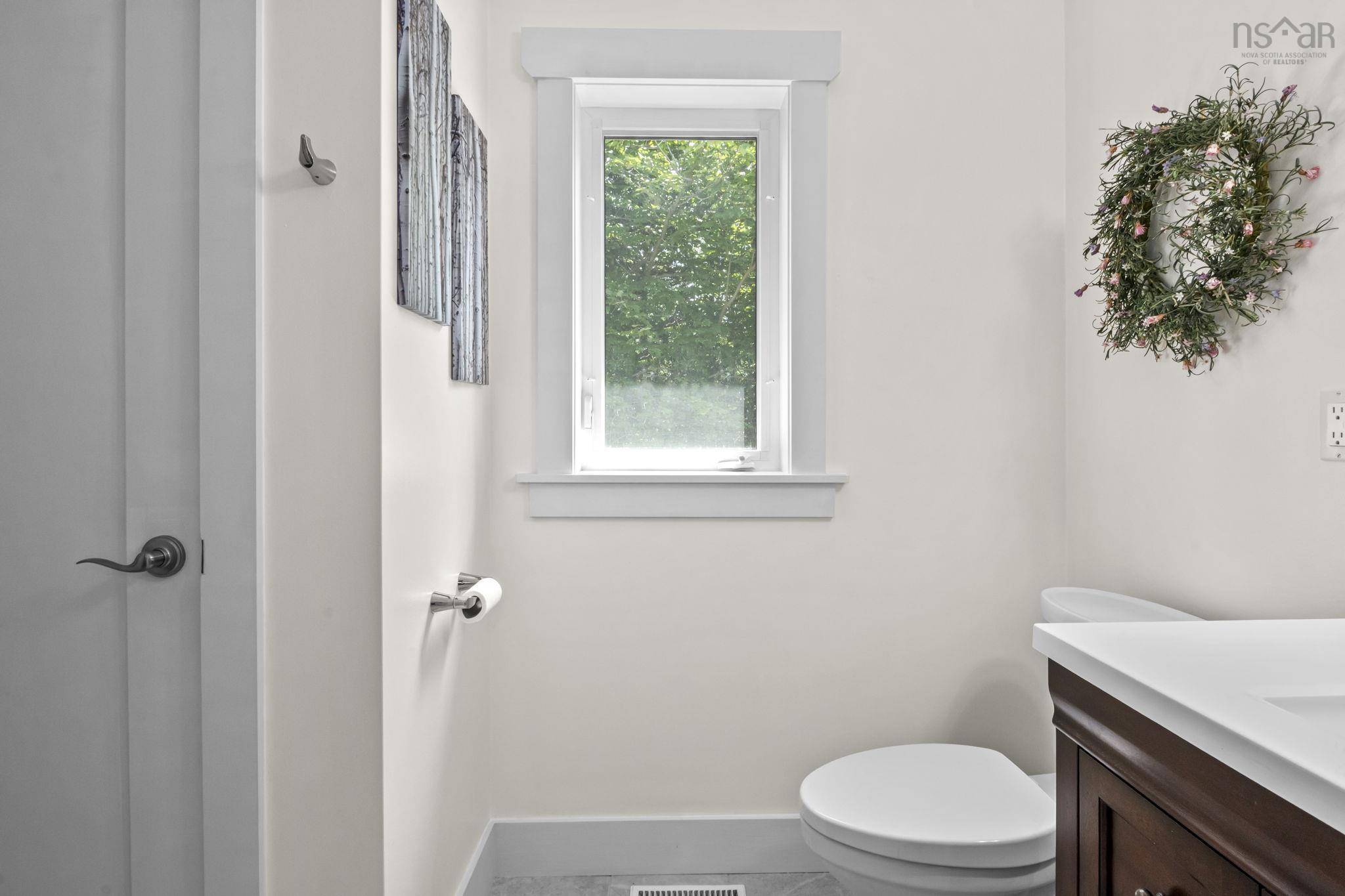 116 Whitecap Ridge, Black Point, NS (MLS® 202618413) — Powder room with a single window, white trim, and light wall paint