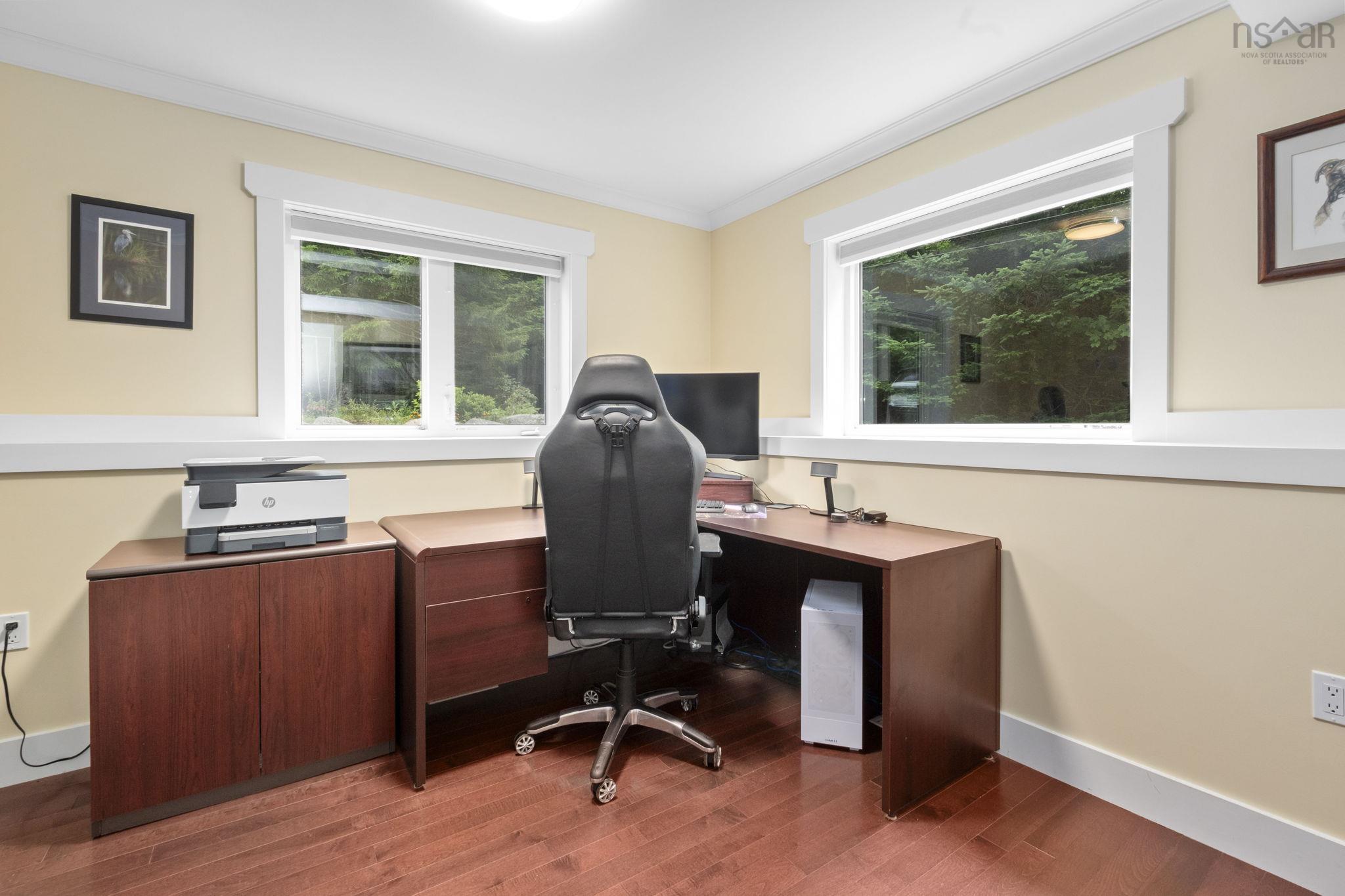 116 Whitecap Ridge, Black Point, NS (MLS® 202618413) — Room featuring dual windows with white trim, wood-finish flooring, and light-toned wall paint