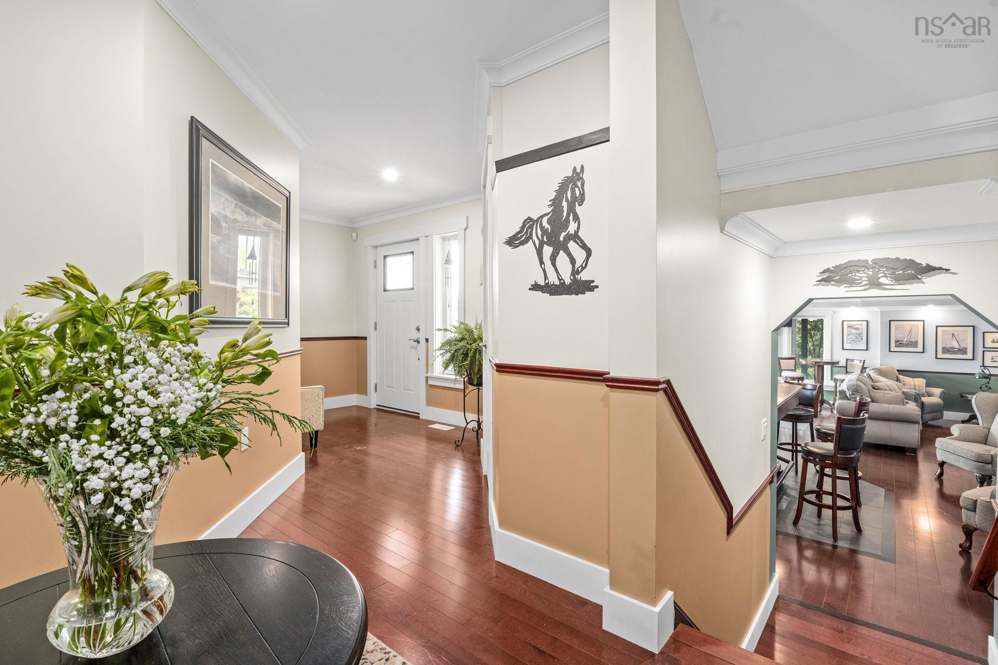 116 Whitecap Ridge, Black Point, NS (MLS® 202618413) — Spacious foyer featuring wood-finish flooring, white trim, and a decorative two-tone wall treatment