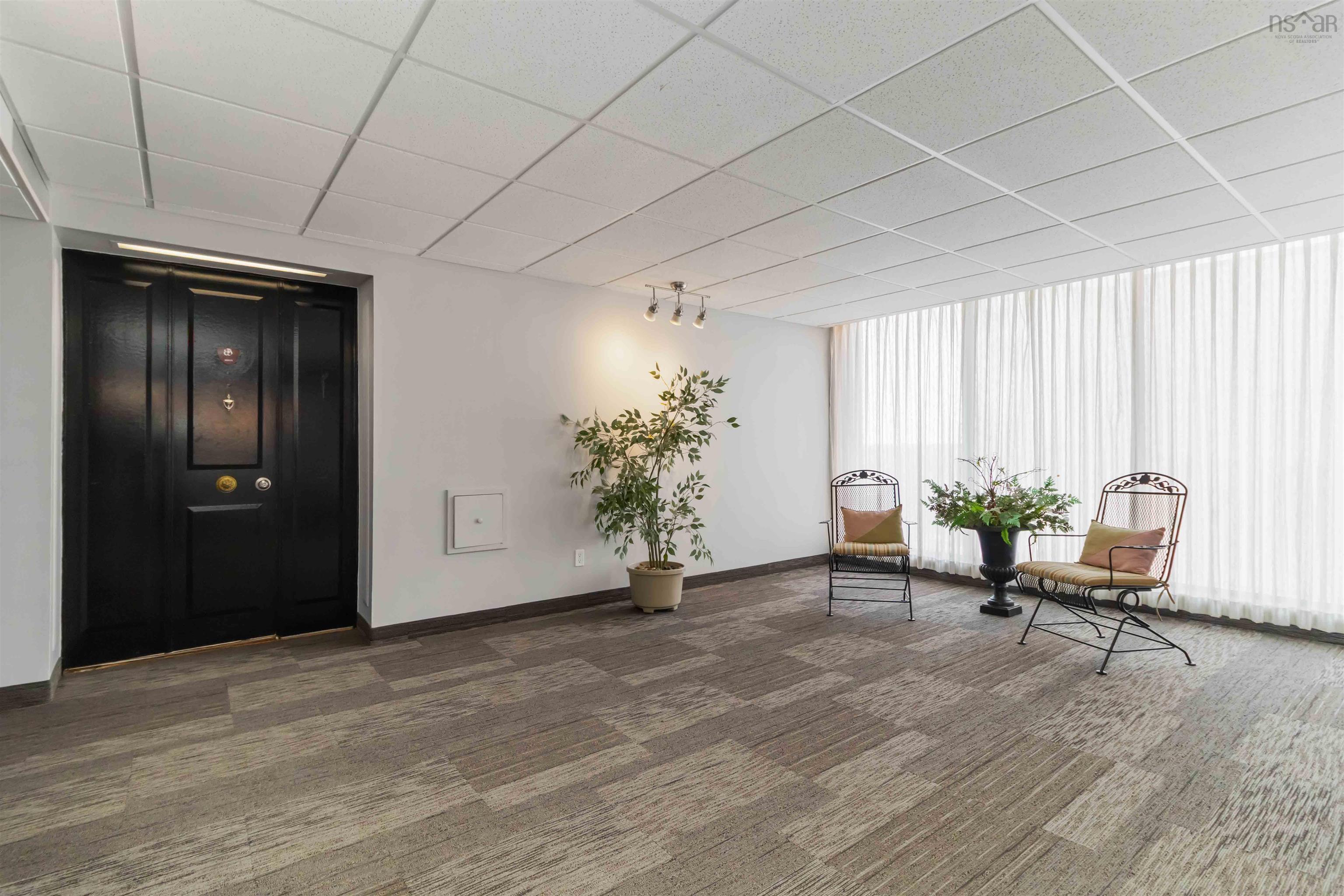 1601 5959 Spring Garden Road, Halifax, NS (MLS® 202620845) — Wall-to-wall carpeting with a geometric pattern, full-height window treatments, and a drop ceiling