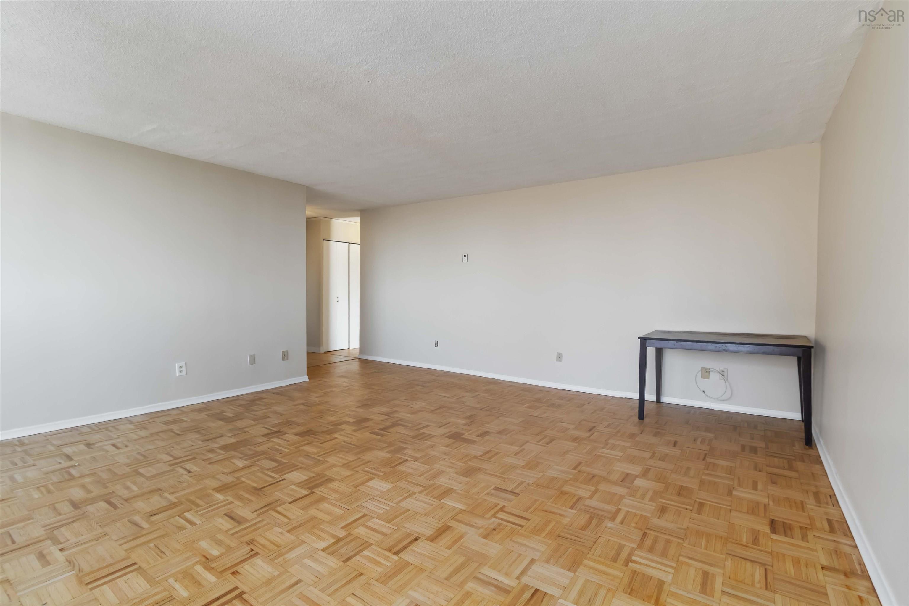 1601 5959 Spring Garden Road, Halifax, NS (MLS® 202620845) — Spacious living area featuring parquet flooring, light neutral wall tones, and an open layout
