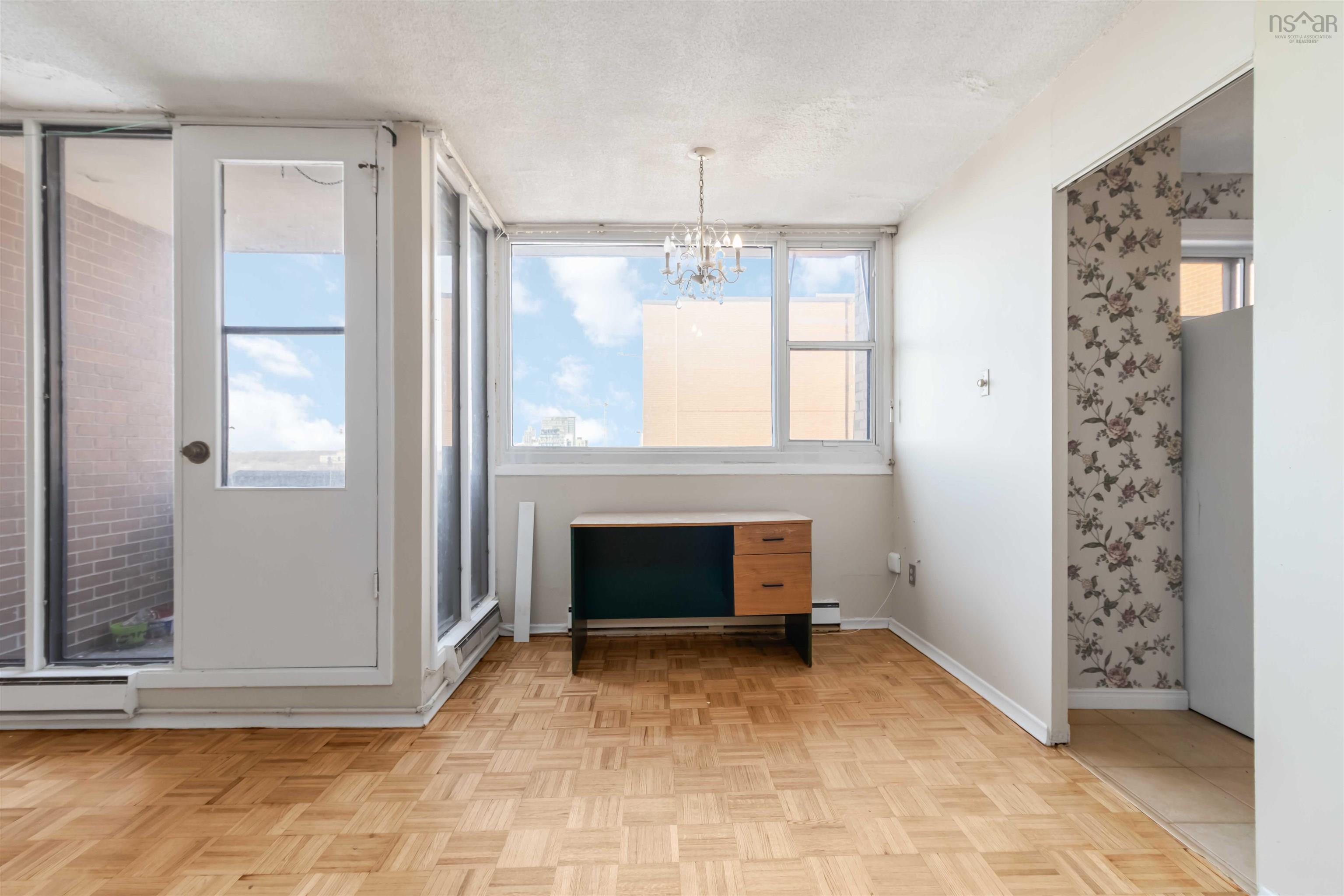1601 5959 Spring Garden Road, Halifax, NS (MLS® 202620845) — Parquet wood flooring, large window with ample natural light, glass-paned exterior door, and a built-in light fixture