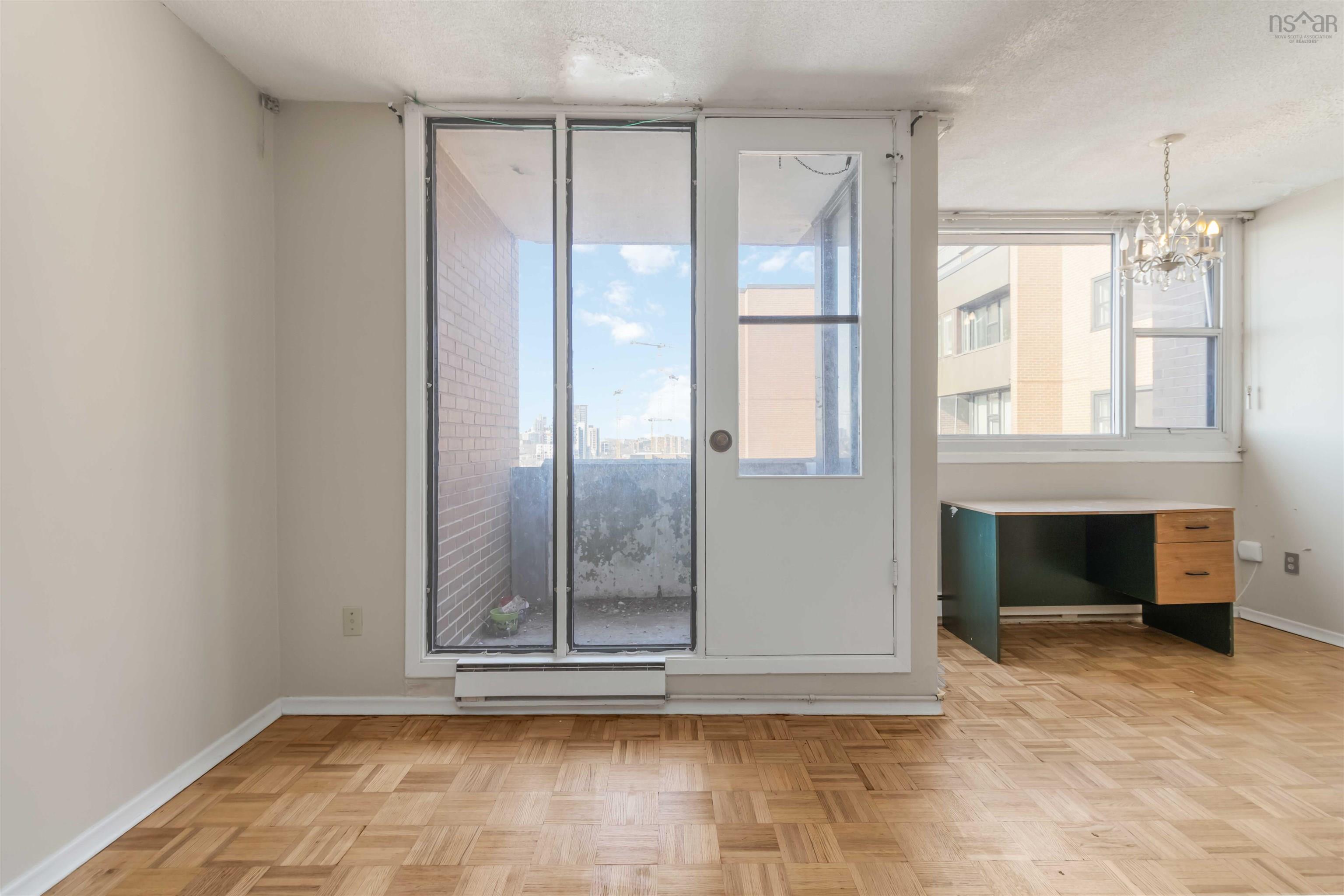 1601 5959 Spring Garden Road, Halifax, NS (MLS® 202620845) — Parquet wood-finish flooring throughout, with a glass-paneled door leading to a balcony