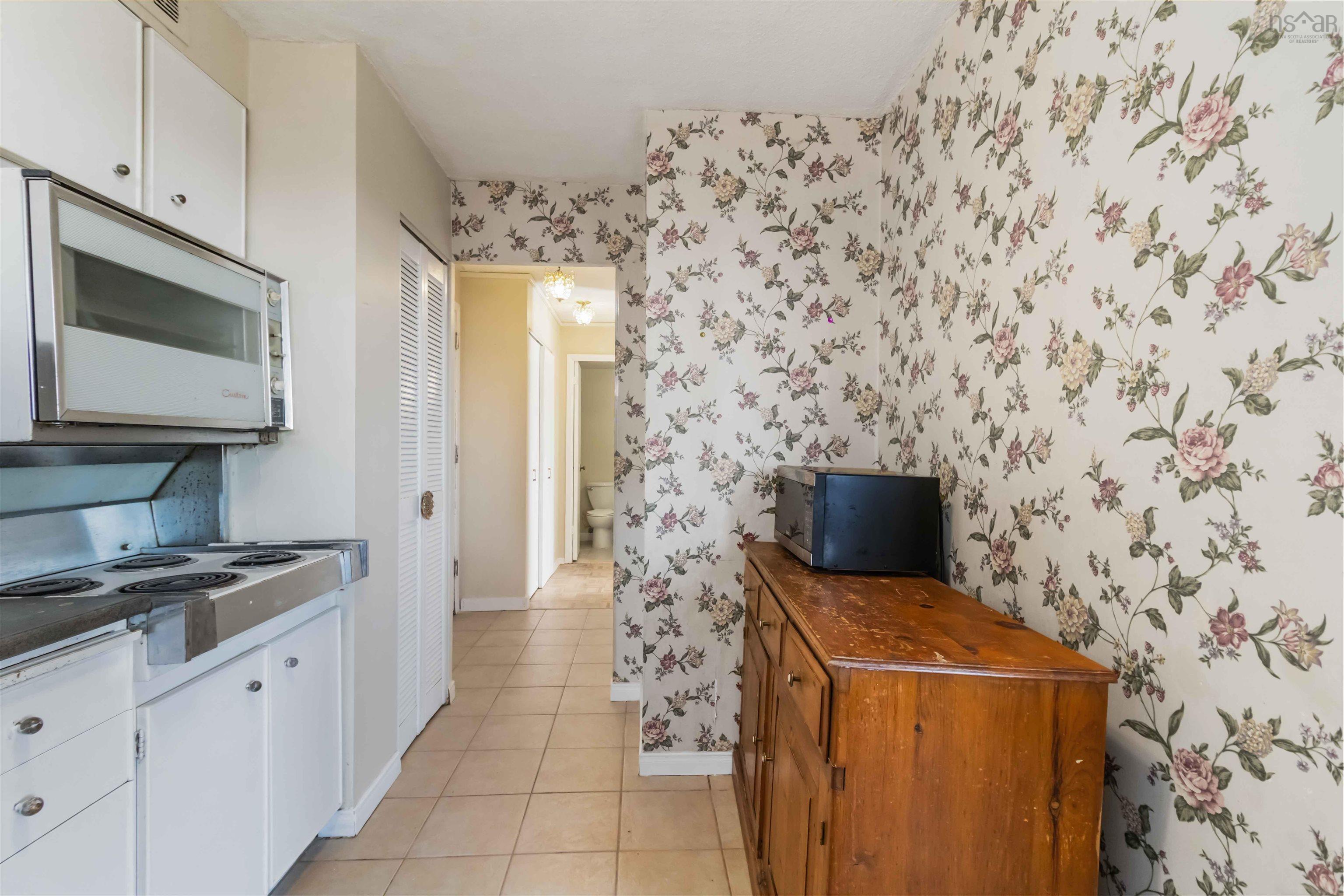 1601 5959 Spring Garden Road, Halifax, NS (MLS® 202620845) — White cabinetry with integrated microwave and cooktop