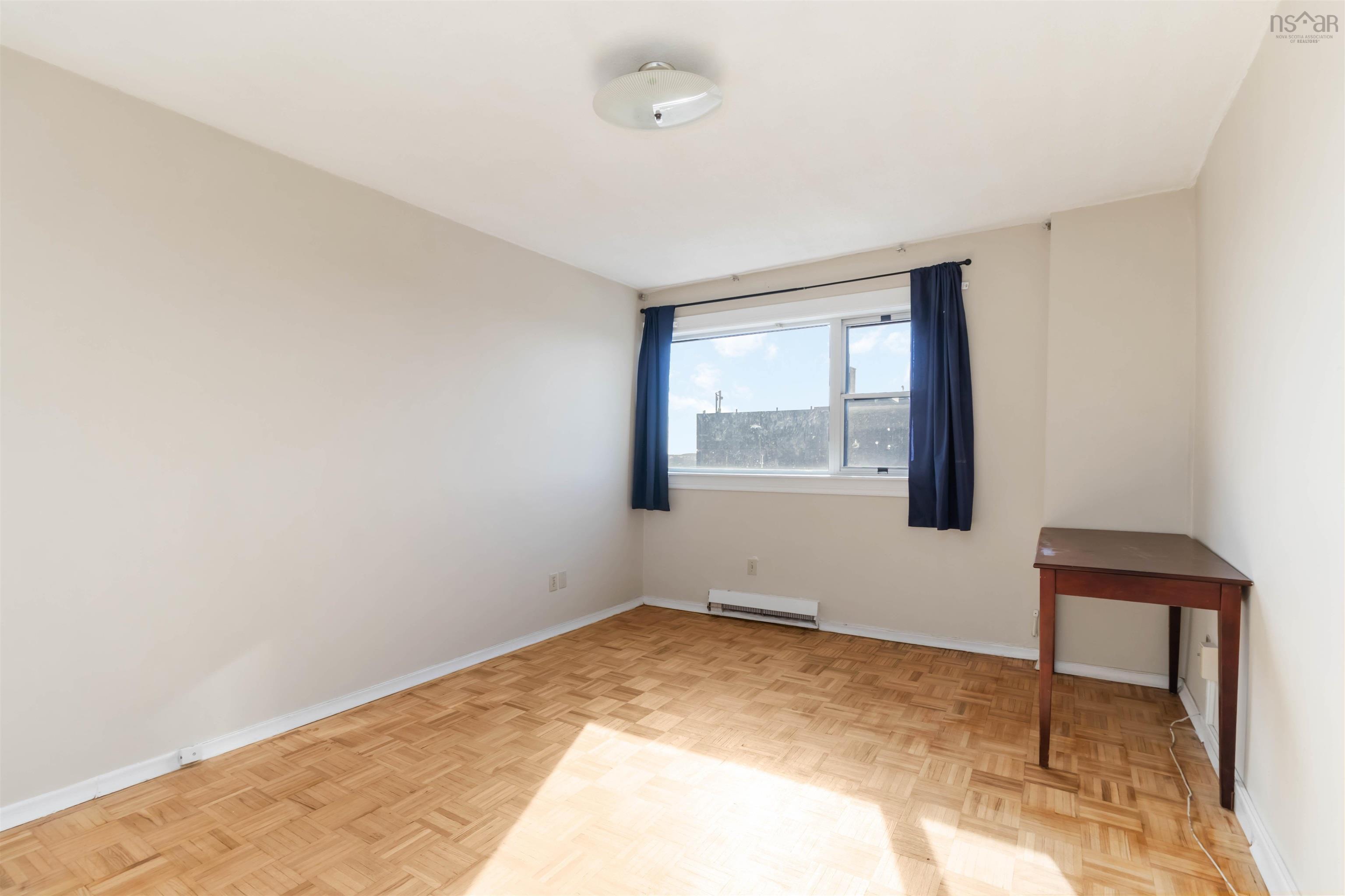 1601 5959 Spring Garden Road, Halifax, NS (MLS® 202620845) — Parquet wood-finish flooring, neutral wall tones, and an overhead flush-mount light fixture