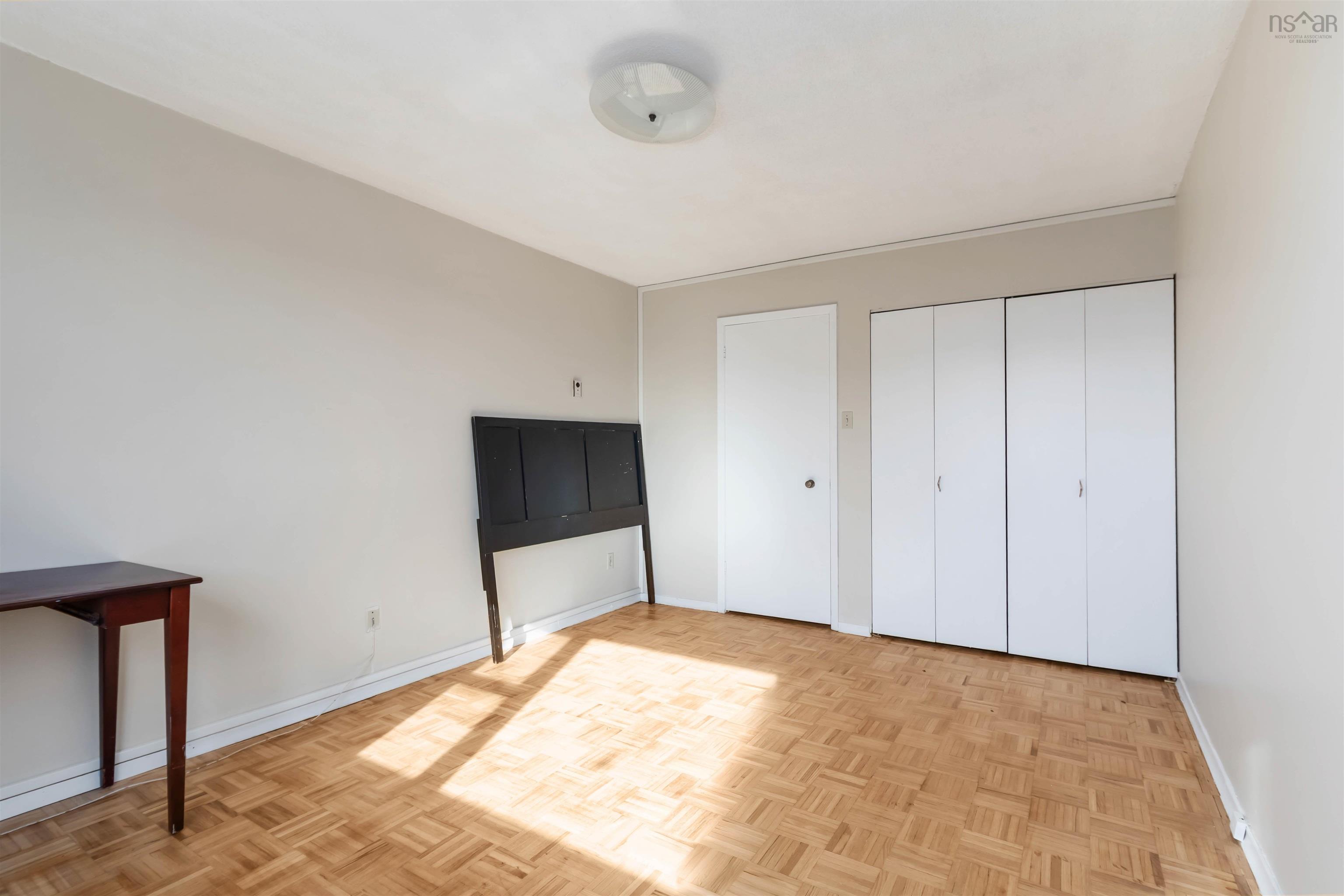 1601 5959 Spring Garden Road, Halifax, NS (MLS® 202620845) — Parquet flooring, neutral wall tones, flush mount ceiling light, white interior door, and bi-fold closet doors