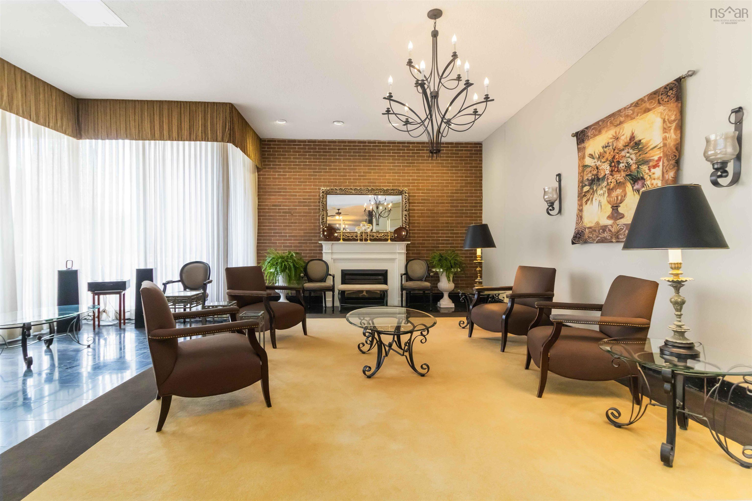 1601 5959 Spring Garden Road, Halifax, NS (MLS® 202620845) — Brick accent wall featuring a white fireplace with mantle