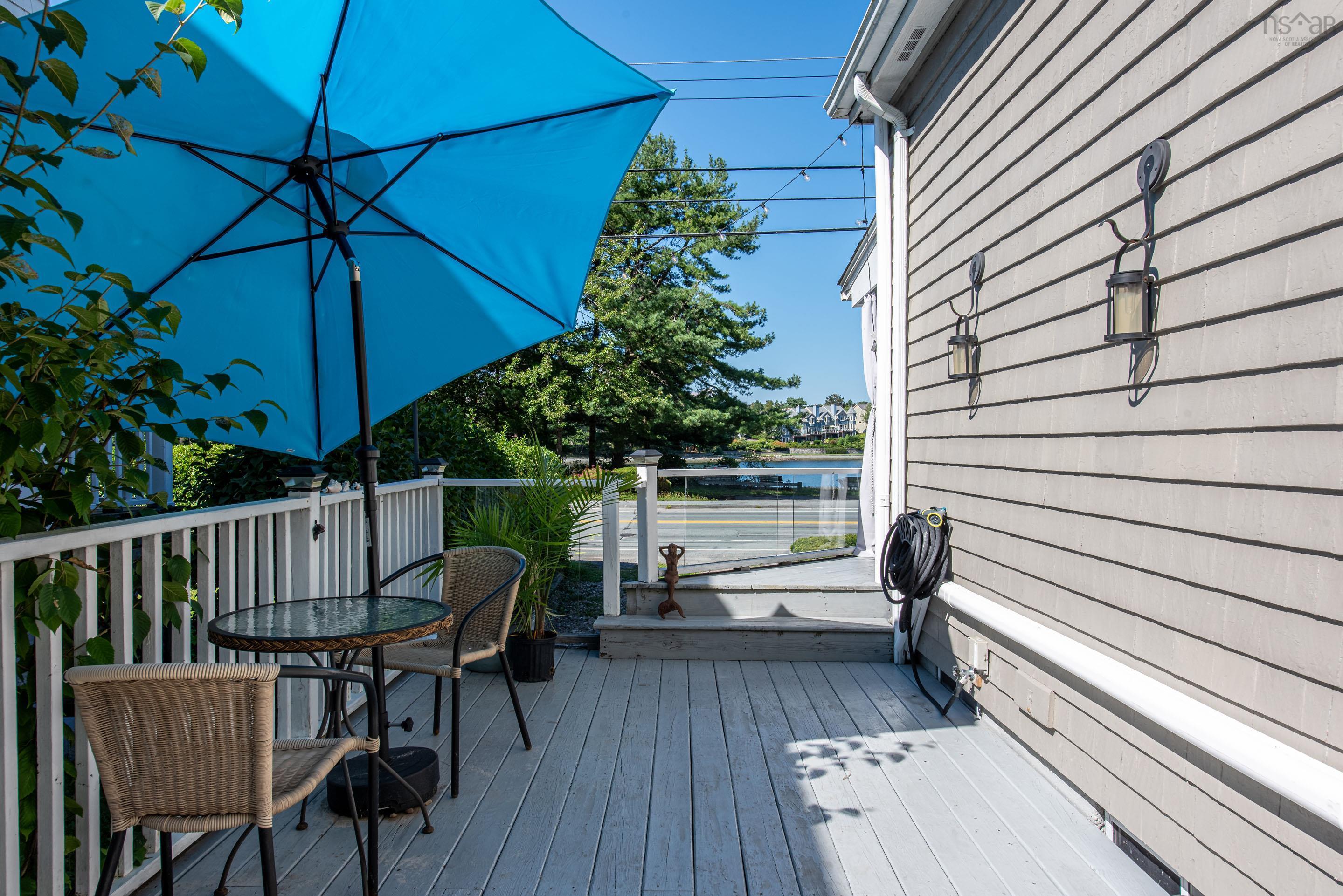 1237 Purcells Cove Road, Halifax, NS (MLS® 202622232) — Spacious deck with wood-finish flooring, white railing, and glass panel accents