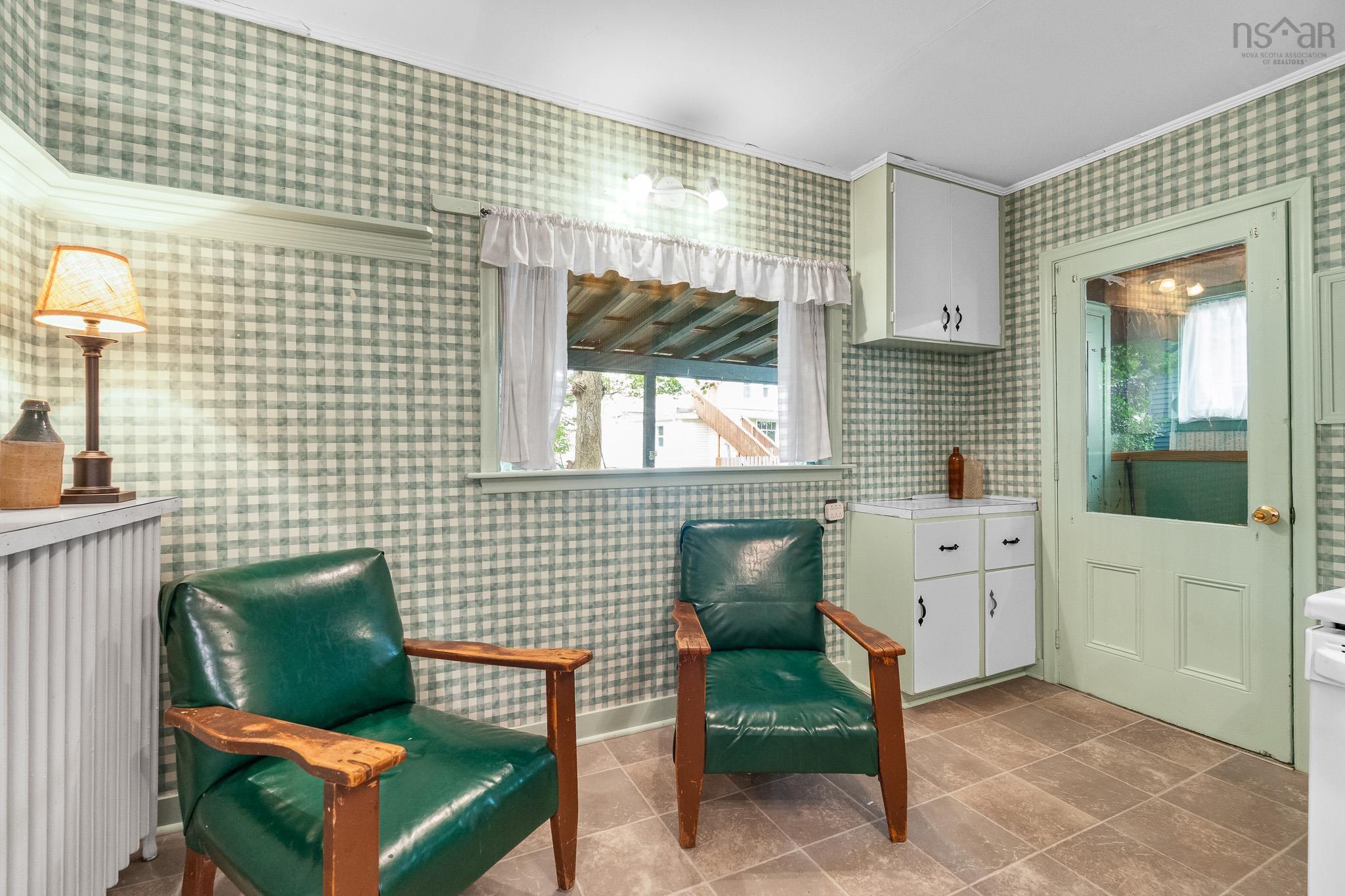 28 Arlington Place, Truro, NS (MLS® 202623012) — A favourite little corner for morning coffee, reading the newspaper and enjoying the view of the garden. Sometimes the simplest moments become the fondest memories.