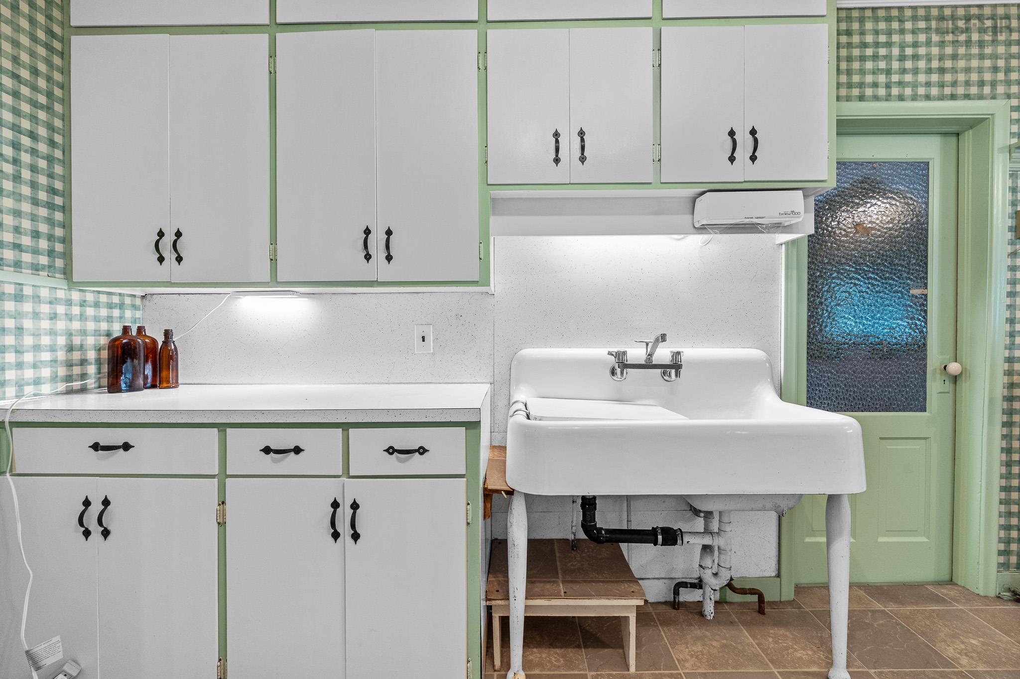 28 Arlington Place, Truro, NS (MLS® 202623012) — Full of character, the kitchen features a classic farmhouse-style sink, nostalgic charm of a well-loved family home.