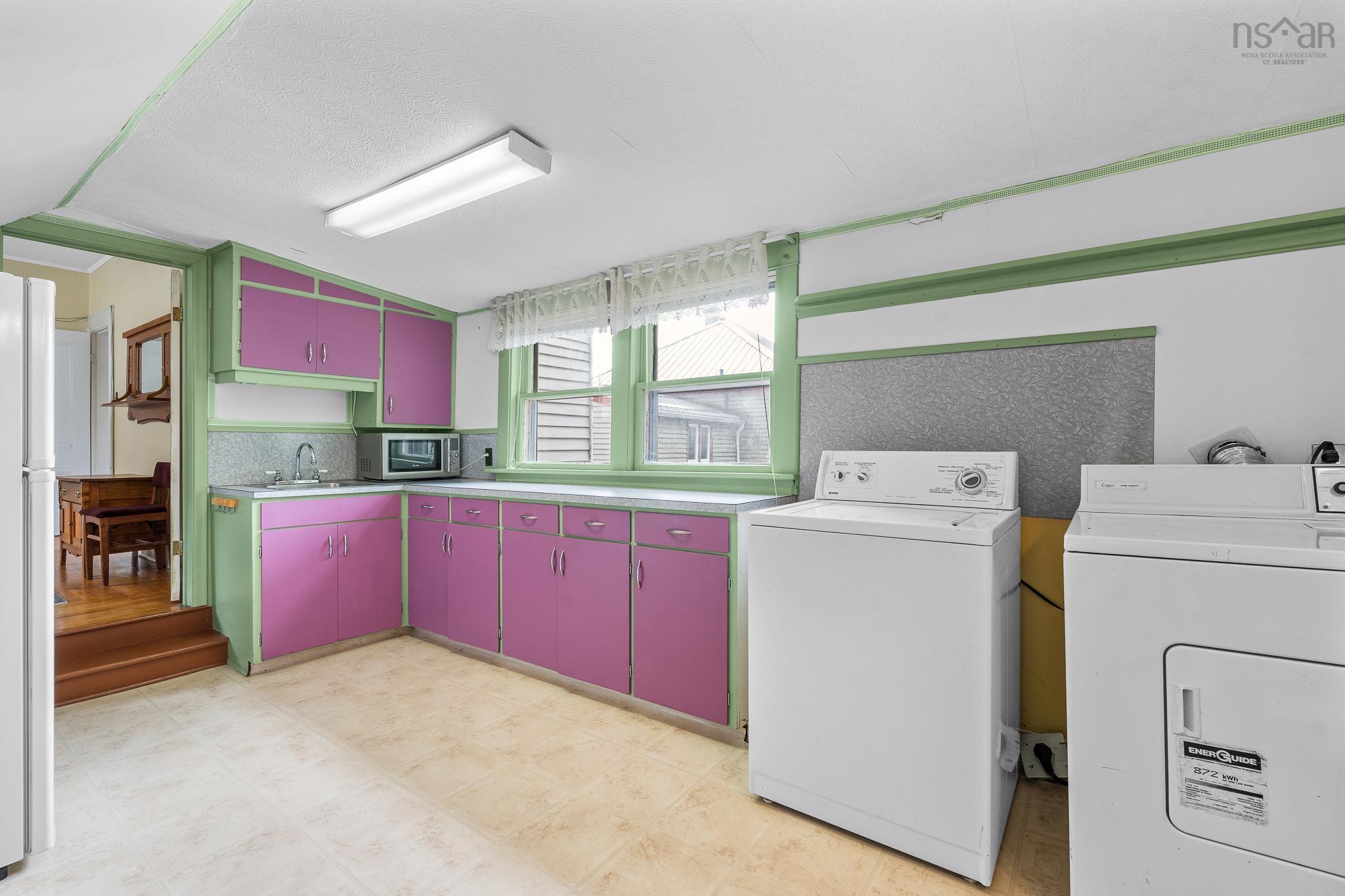 28 Arlington Place, Truro, NS (MLS® 202623012) — Off one of the bedrooms is an unexpectedly large and wonderfully versatile bonus room, complete with laundry, abundant cabinetry and a sink.