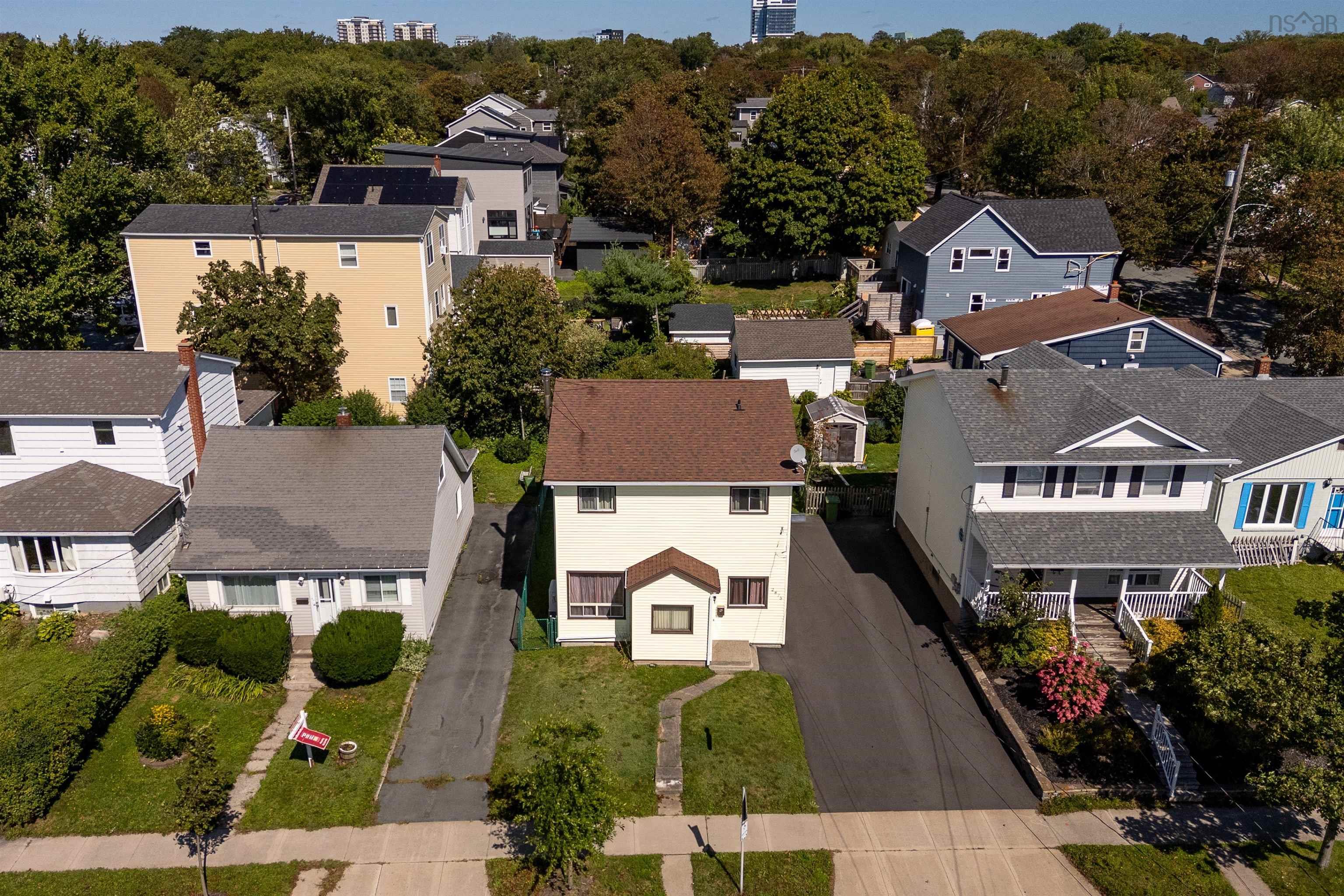 2875 Connaught Avenue, Halifax, NS (MLS® 202623267) — Two-story residence with a brown shingle roof, light-colored siding, and a front yard with mature landscaping
