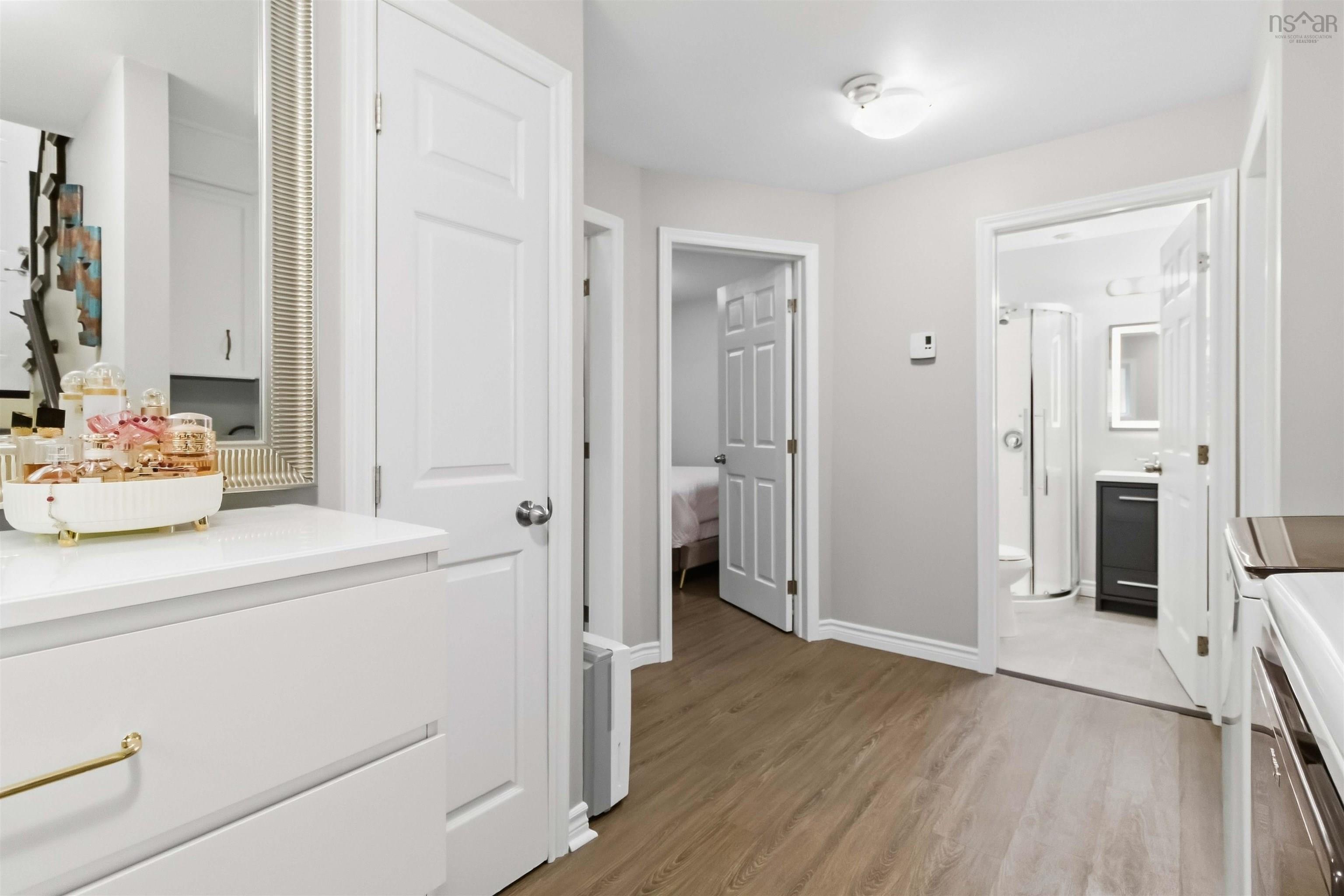 34 Lindsay Court, Lower Sackville, NS (MLS® 202624063) — Wood-finish flooring throughout, white paneled doors, and a built-in vanity with gold-tone hardware