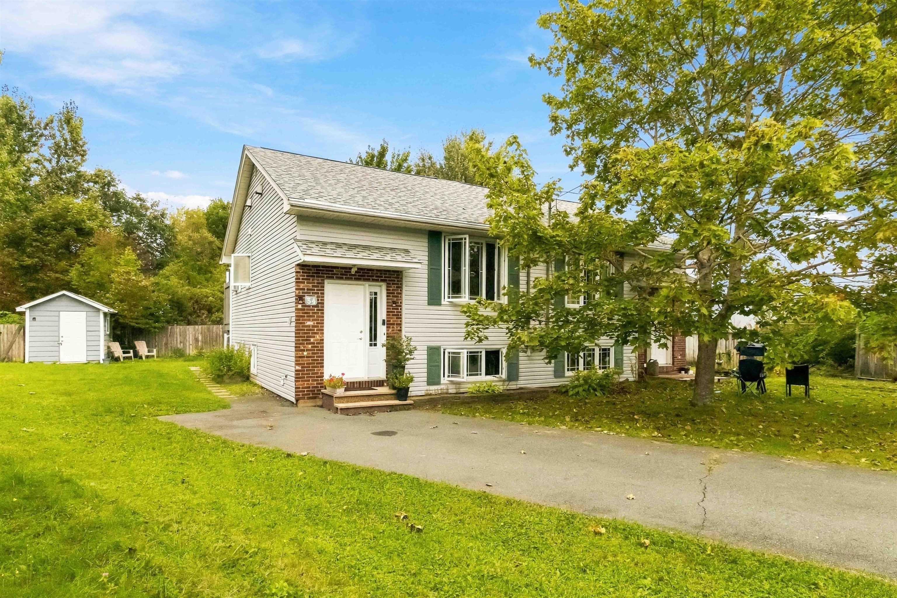 34 Lindsay Court, Lower Sackville, NS (MLS® 202624063) — Light gray siding exterior with a partial brick facade, asphalt shingle roof, and a white entry door