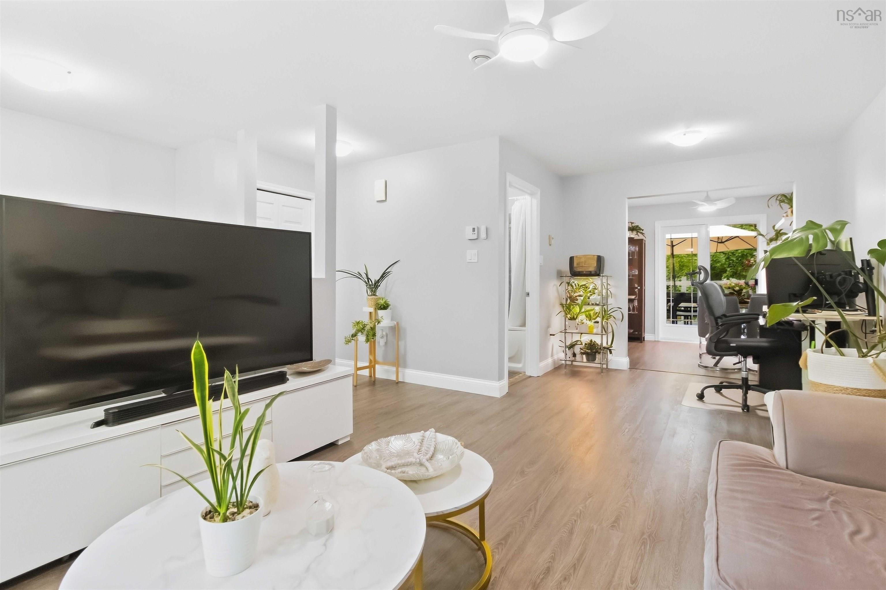 34 Lindsay Court, Lower Sackville, NS (MLS® 202624063) — Wood-finish flooring throughout, white ceiling fan, recessed lighting, and sliding glass doors