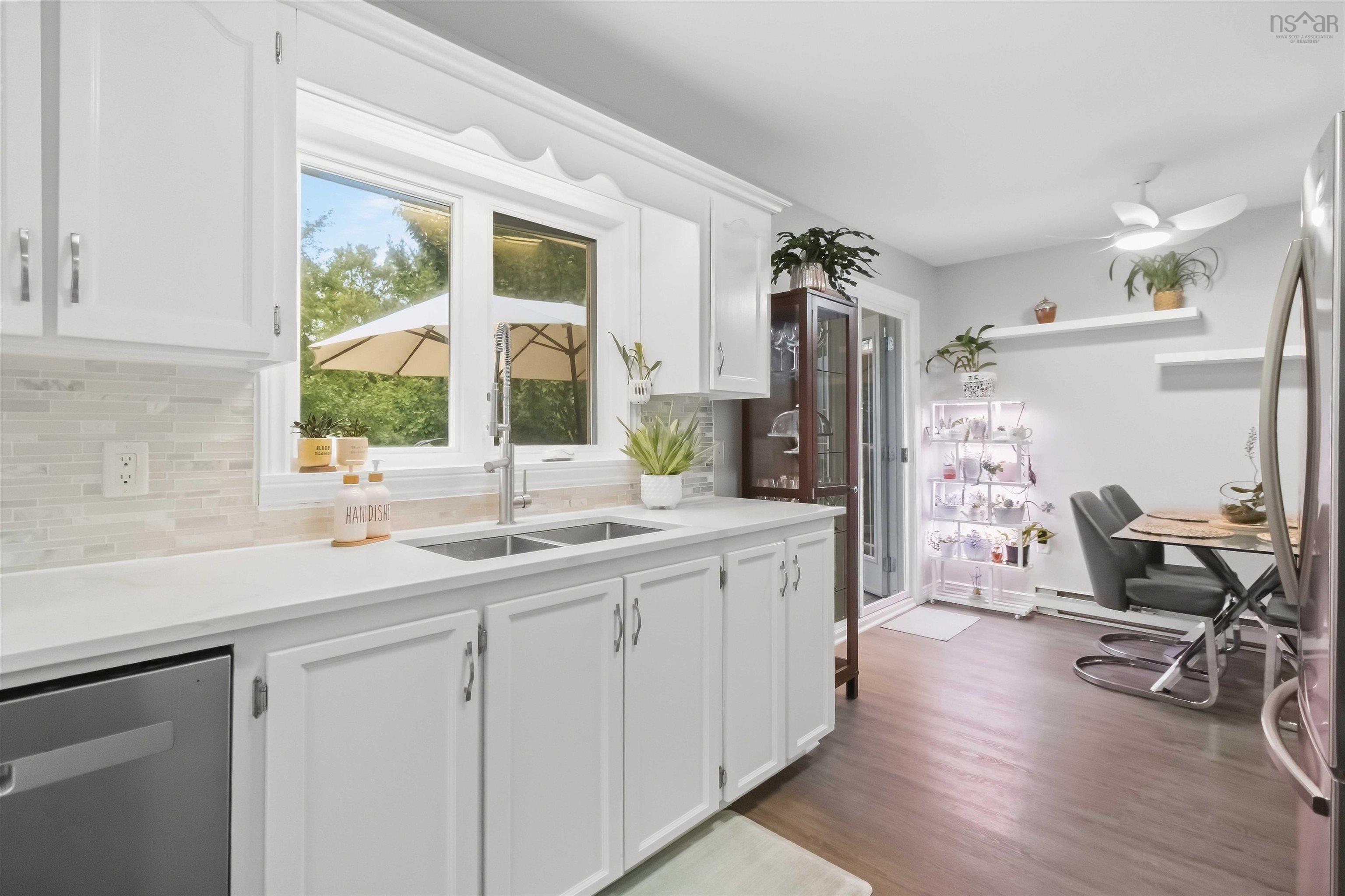 34 Lindsay Court, Lower Sackville, NS (MLS® 202624063) — White shaker-style cabinetry, stainless steel sink, light-toned mosaic tile backsplash, and light countertops