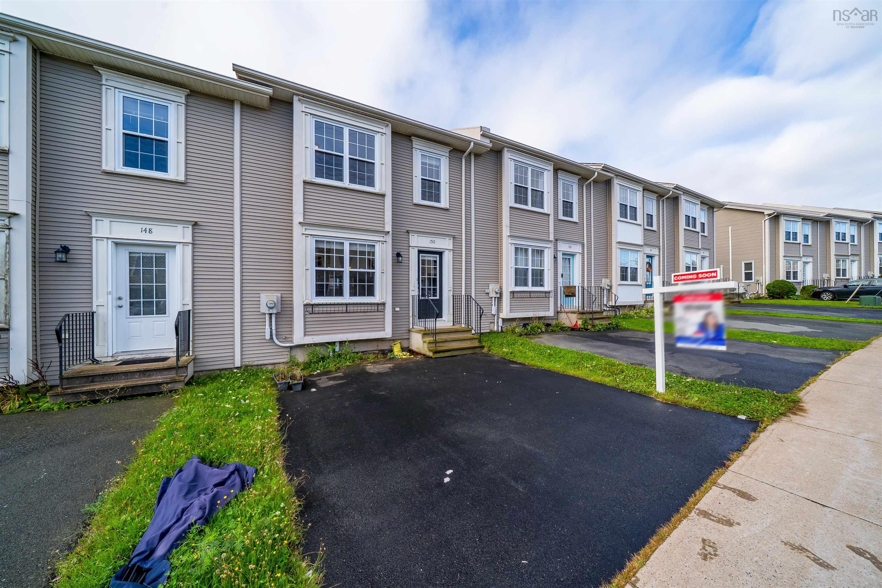 150 Transom Drive, Halifax, NS (MLS® 202625460) — Townhouse exterior featuring light gray siding, white window trim, multiple windows, and individual paved driveways