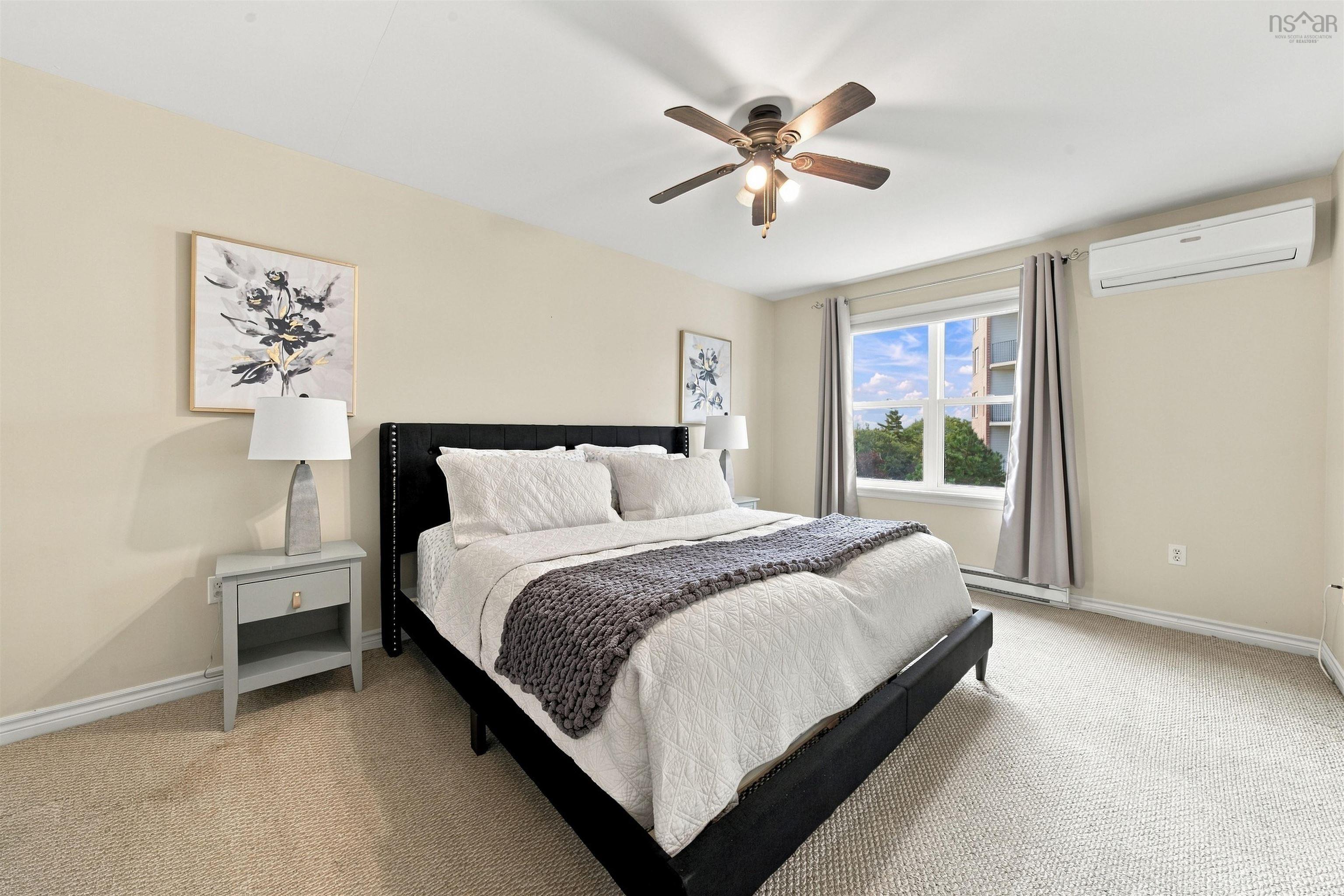 150 Transom Drive, Halifax, NS (MLS® 202625460) — Carpeted flooring, ceiling fan, white trim, window with white frame, and wall-mounted air conditioning unit