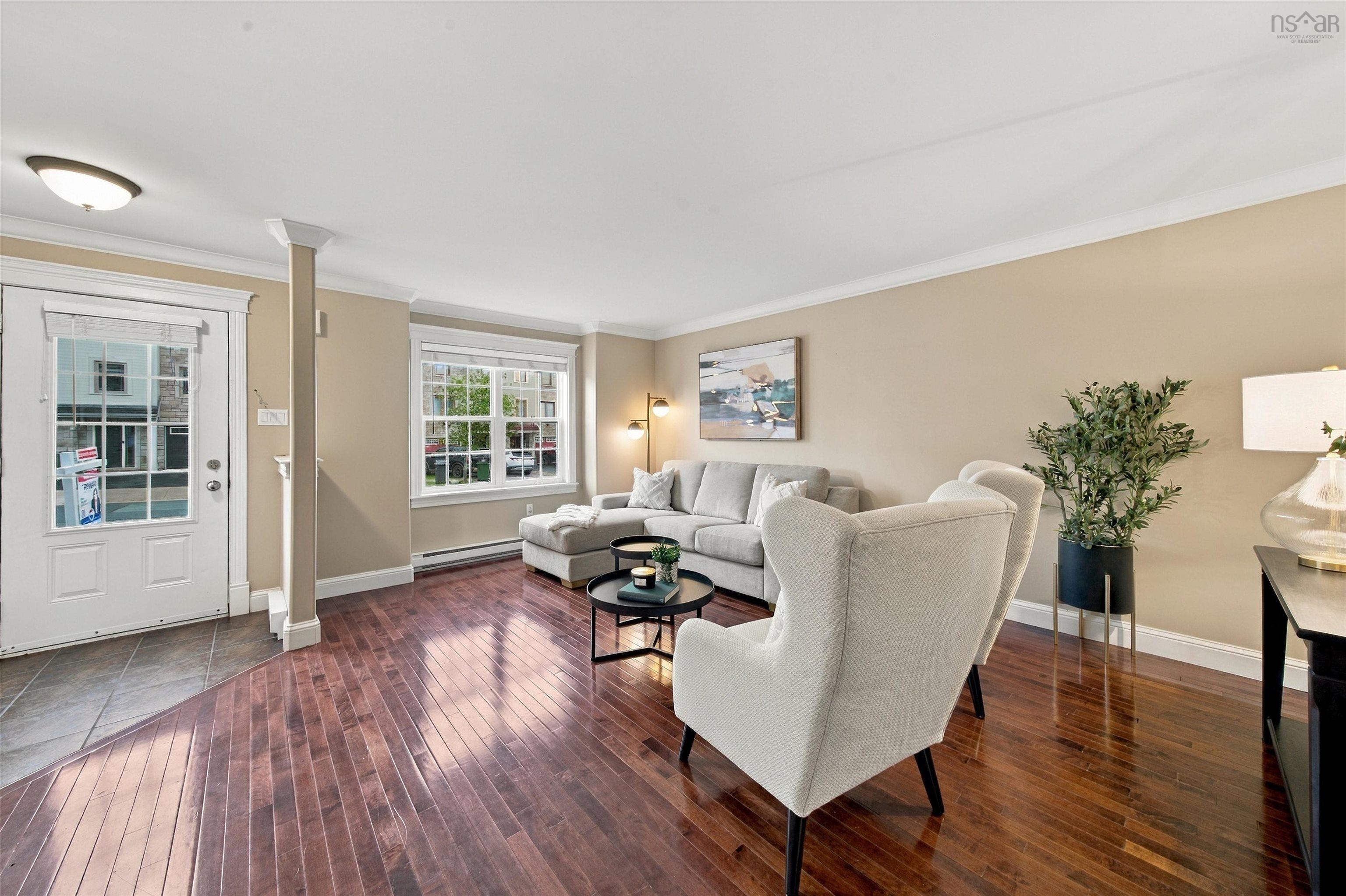 150 Transom Drive, Halifax, NS (MLS® 202625460) — Wood-finish flooring, neutral wall tones, crown molding, and a front entry door with transom window