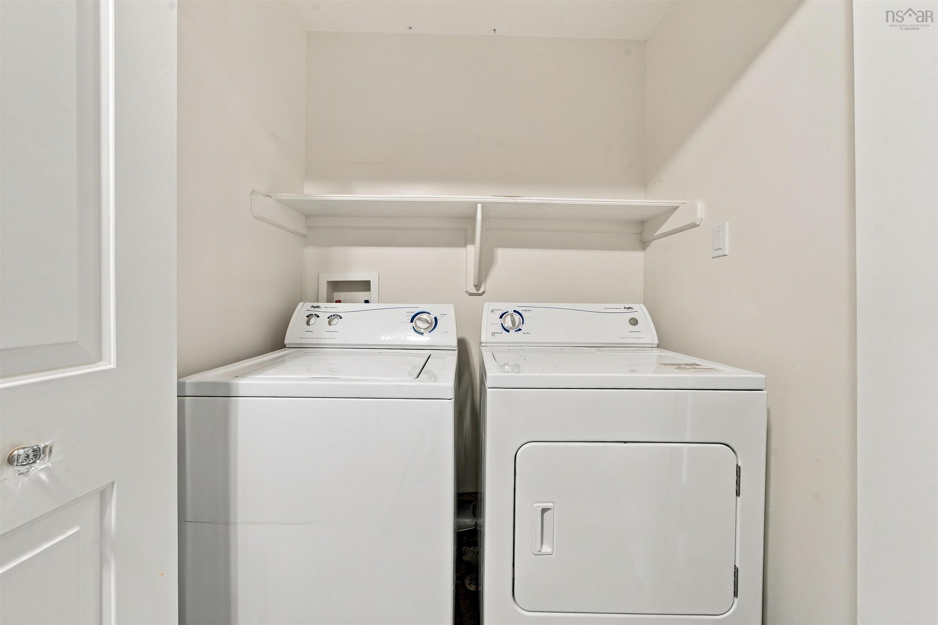 150 Transom Drive, Halifax, NS (MLS® 202625460) — Utility area featuring a white top-load washing machine, white front-load dryer, and an upper storage shelf
