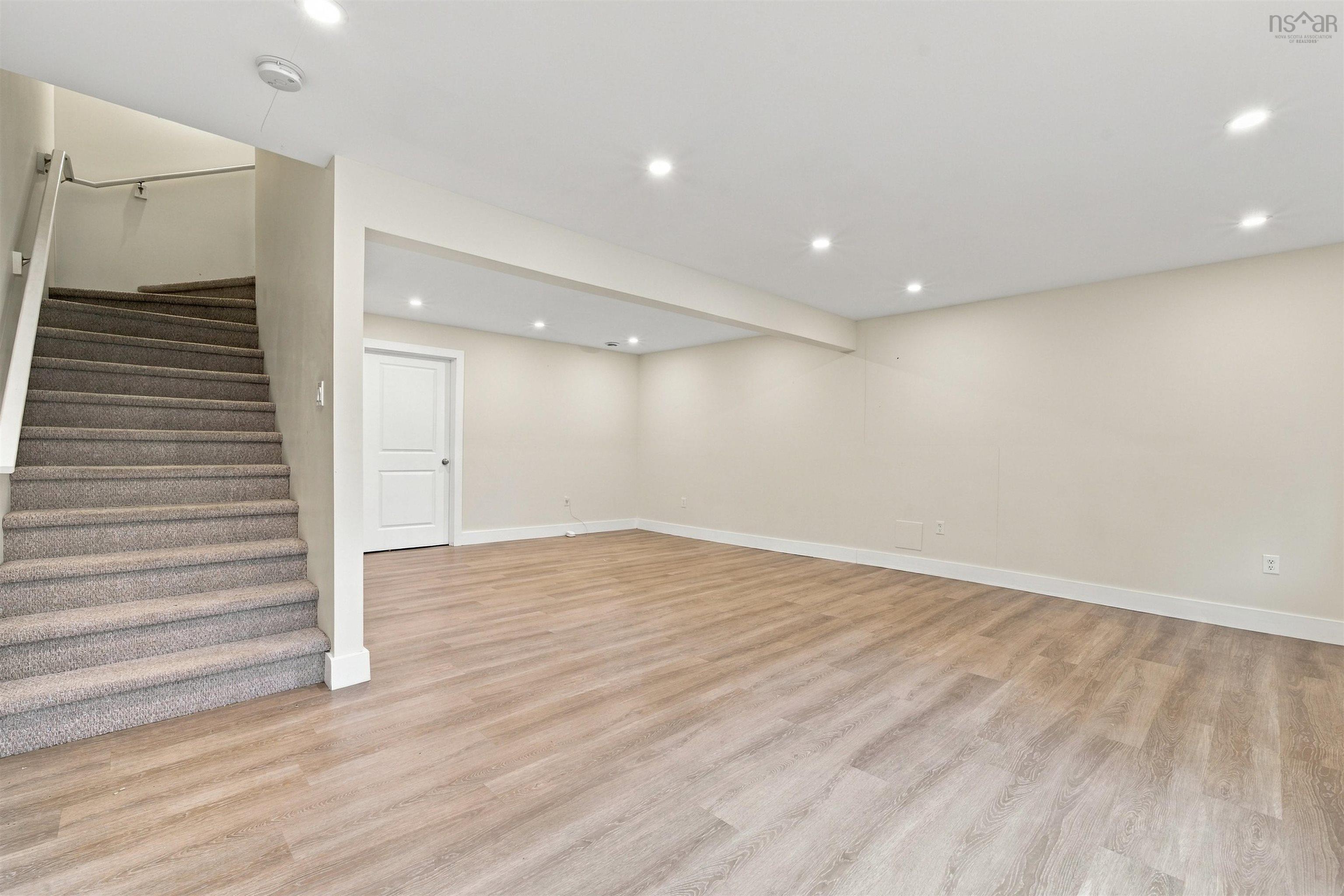 150 Transom Drive, Halifax, NS (MLS® 202625460) — Recessed lighting illuminates the open-concept room featuring wood-finish flooring and a white paneled door