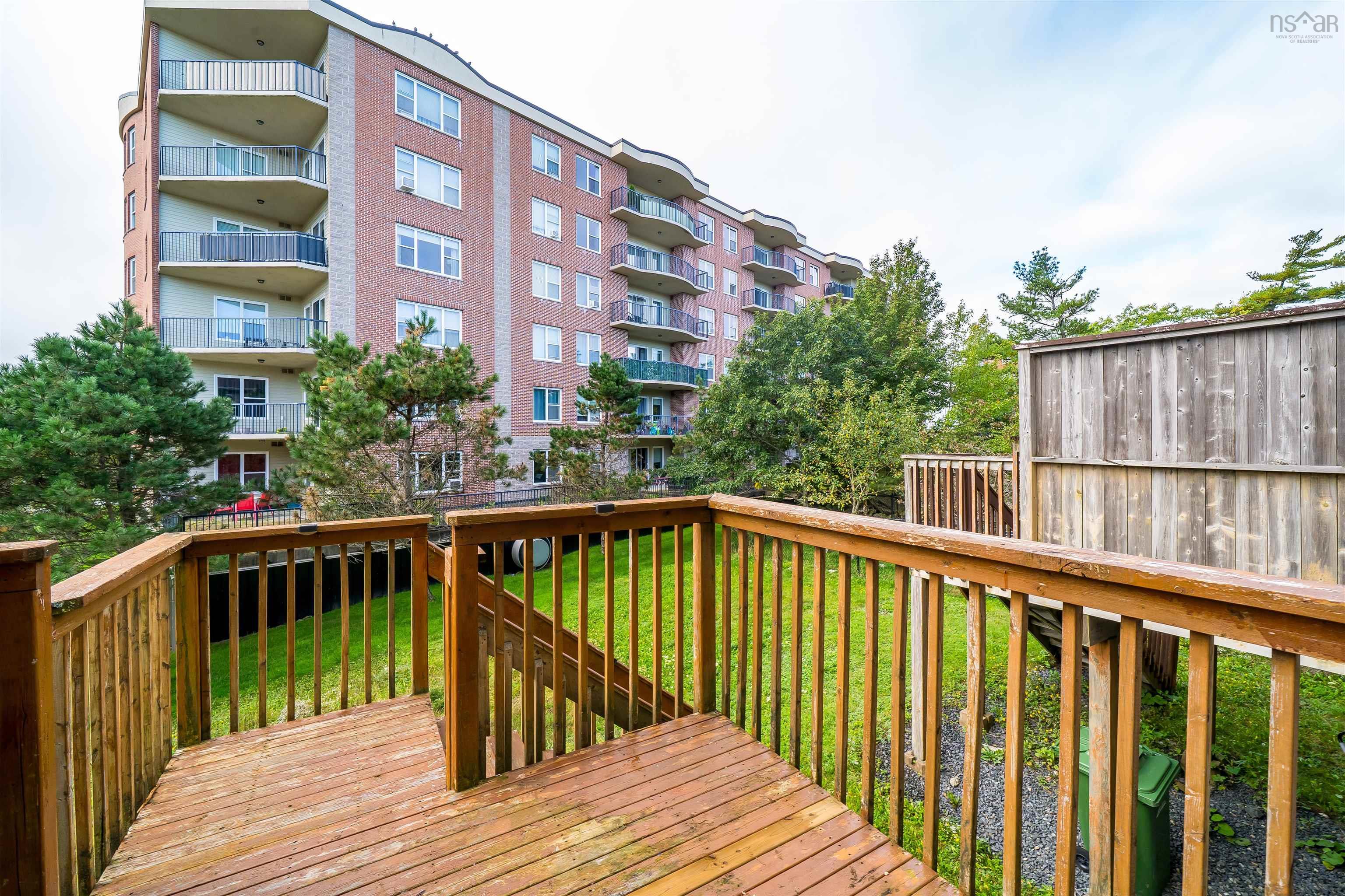 150 Transom Drive, Halifax, NS (MLS® 202625460) — Multi-level wood deck with natural wood railings, overlooking a grassy area and mature trees