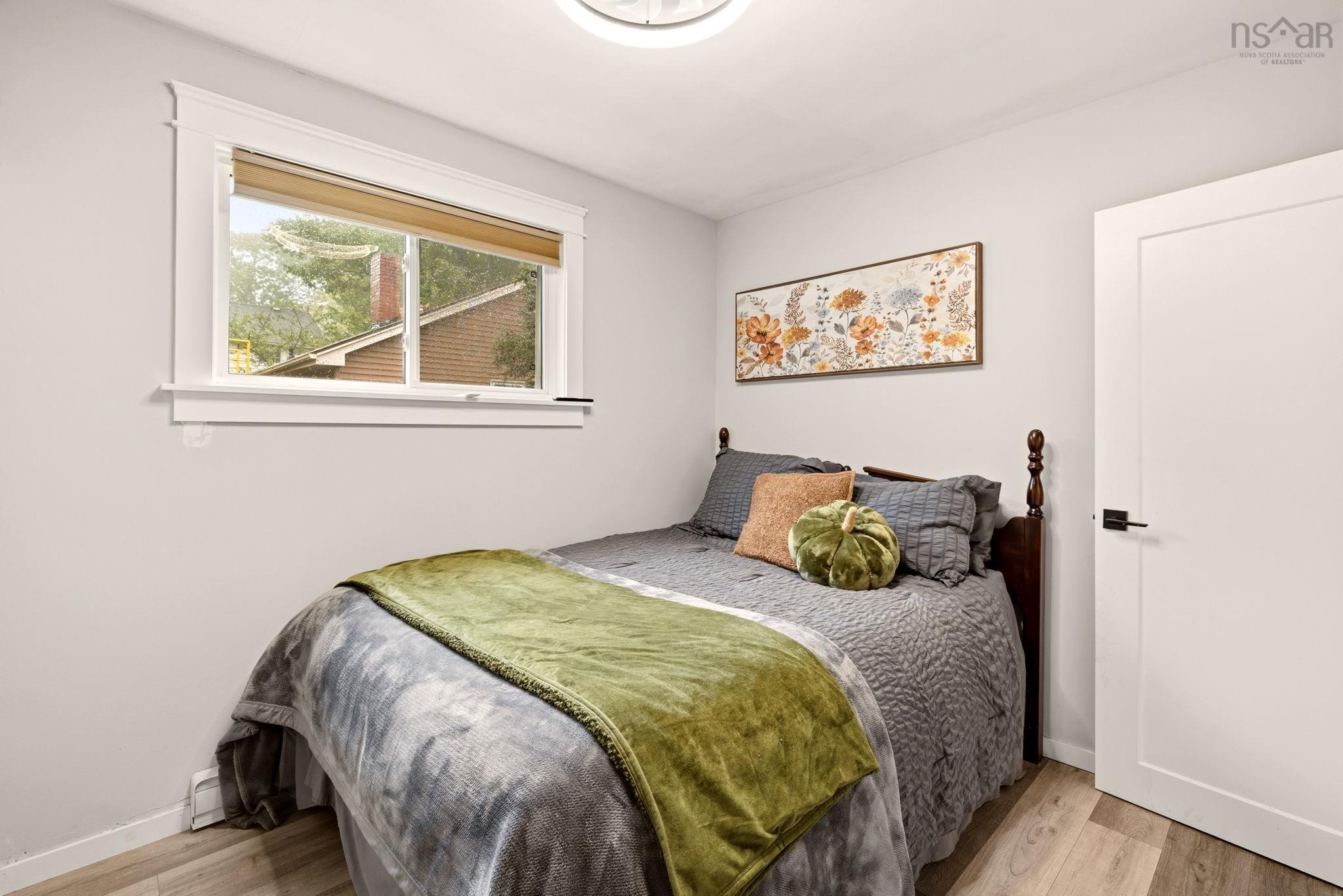 25 Circle Drive, Halifax, NS (MLS® 202625881) — Neutral-toned walls, wood-finish flooring, sliding window with traditional trim, and a solid-core interior door with matte black hardware