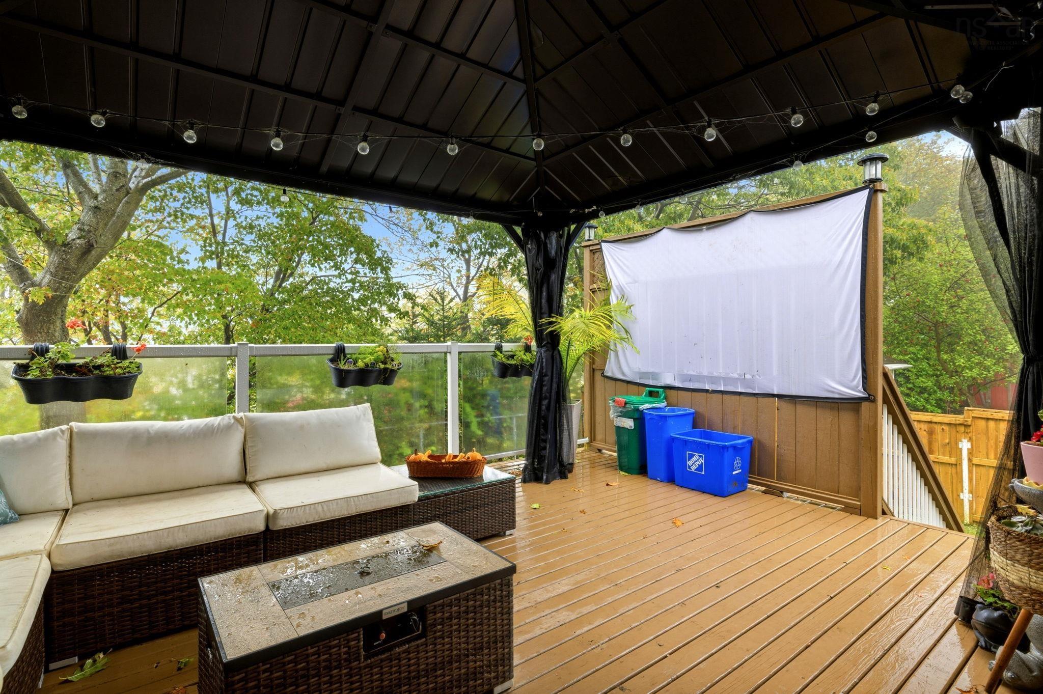 25 Circle Drive, Halifax, NS (MLS® 202625881) — Covered deck featuring a dark metal gazebo roof, wood-finish decking, and a glass-paneled railing