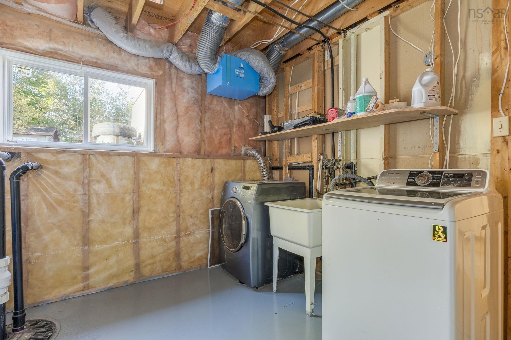 128 Doherty Drive, Lawrencetown, NS (MLS® 202625891) — Utility area featuring a sliding window, a utility basin, and exposed stud framing