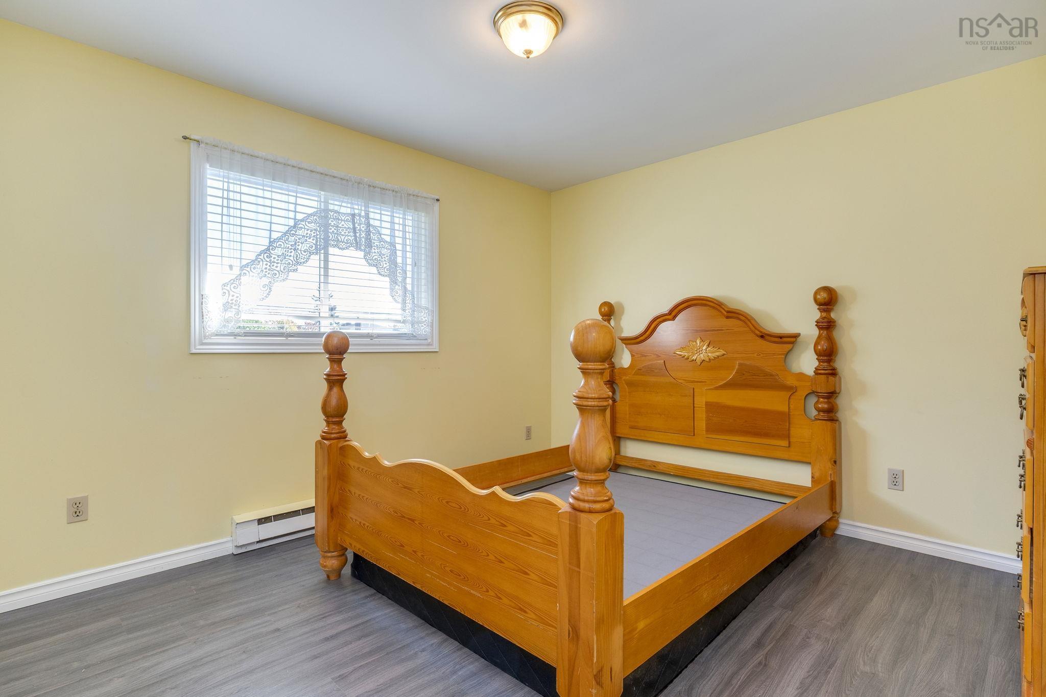 128 Doherty Drive, Lawrencetown, NS (MLS® 202625891) — Room featuring wood-finish flooring, neutral-toned walls, and a center-mounted flush light fixture, including a horizontal window with white trim