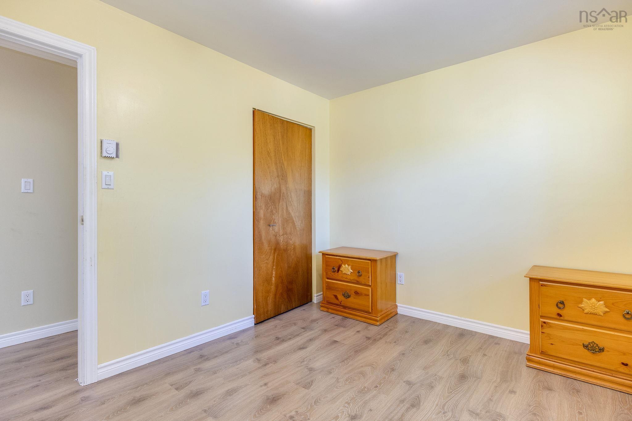 128 Doherty Drive, Lawrencetown, NS (MLS® 202625891) — Interior room featuring light-toned wood-finish flooring and a natural wood-finish door