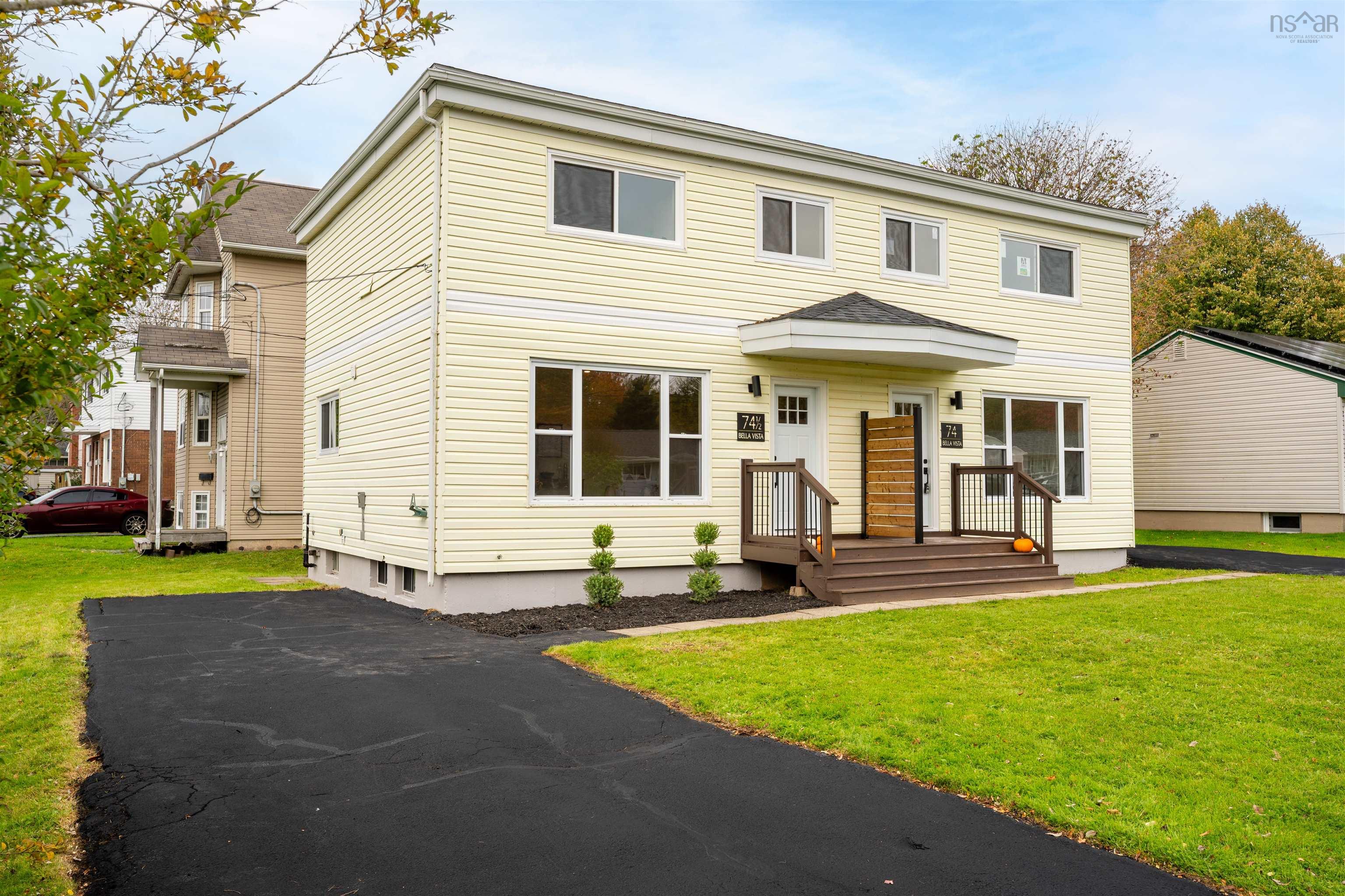 74 1/2 Belle Vista Drive, Dartmouth, NS (MLS® 202625912) — Exterior featuring light-colored horizontal siding, dual entryways with raised wood-finish porches, metal railing, and a private asphalt driveway