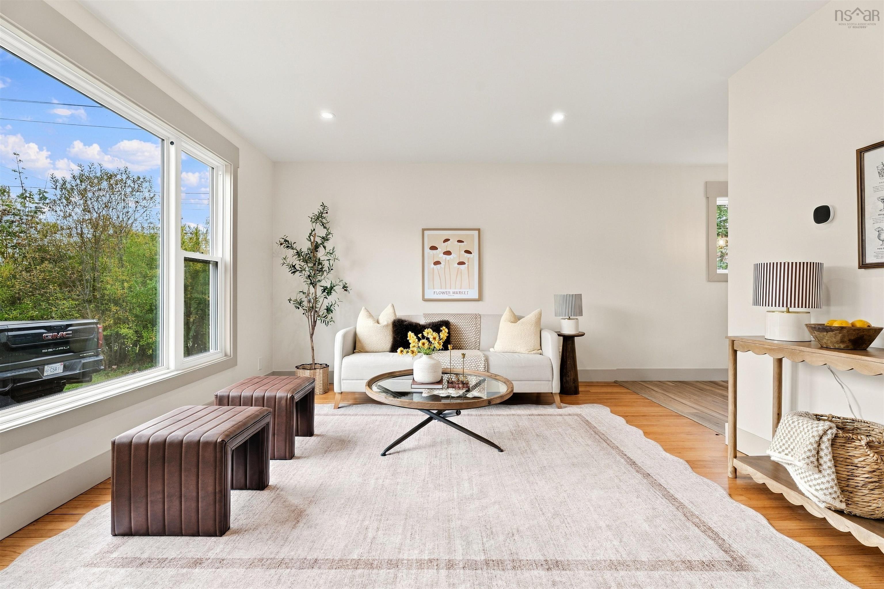 74 1/2 Belle Vista Drive, Dartmouth, NS (MLS® 202625912) — Living area featuring wood-finish flooring, neutral wall paint, and an oversized picture window