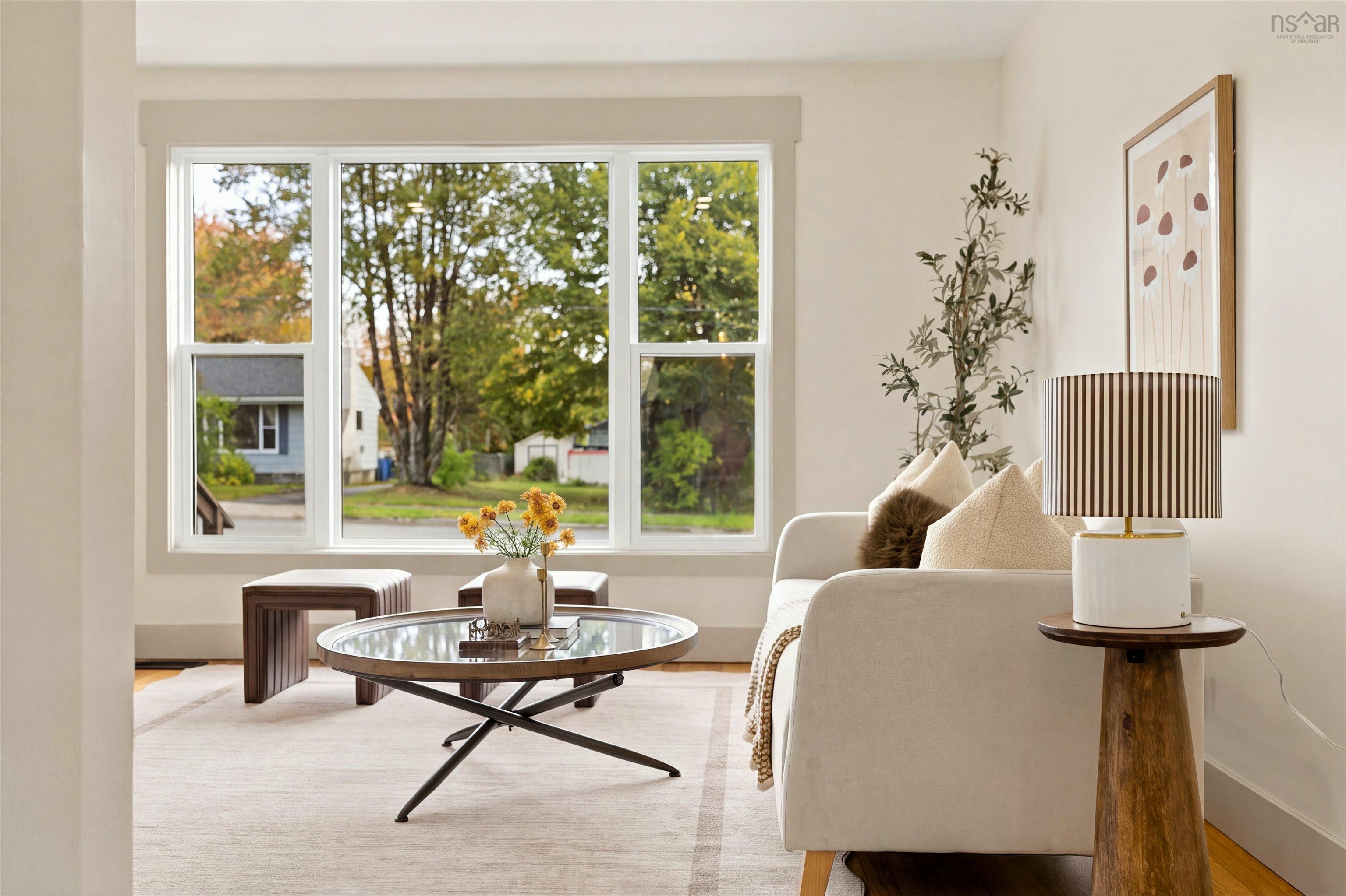74 1/2 Belle Vista Drive, Dartmouth, NS (MLS® 202625912) — Large triple-pane window with neutral casing and polished wood-finish flooring